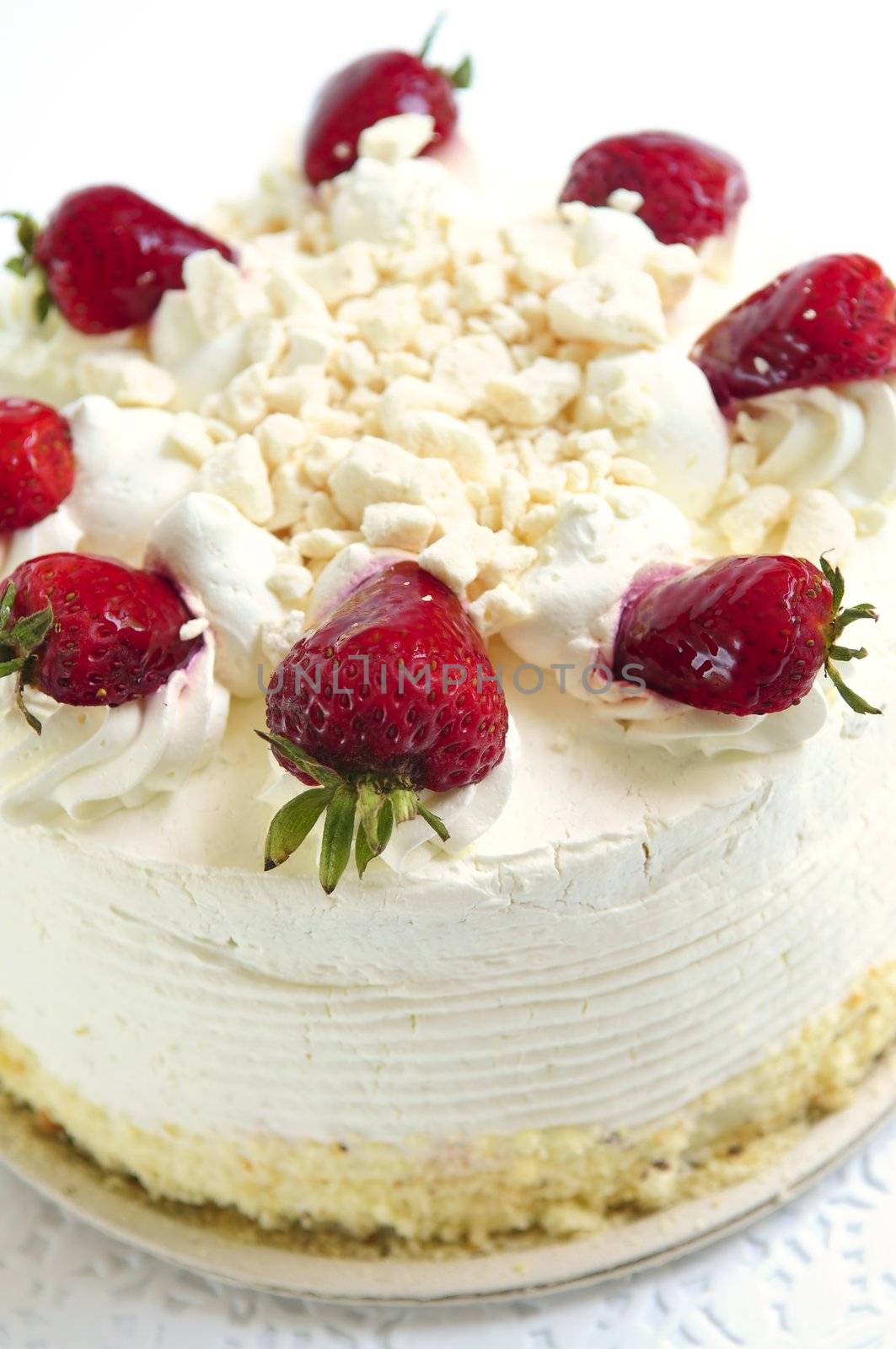 Whole strawberry meringue cake on white background