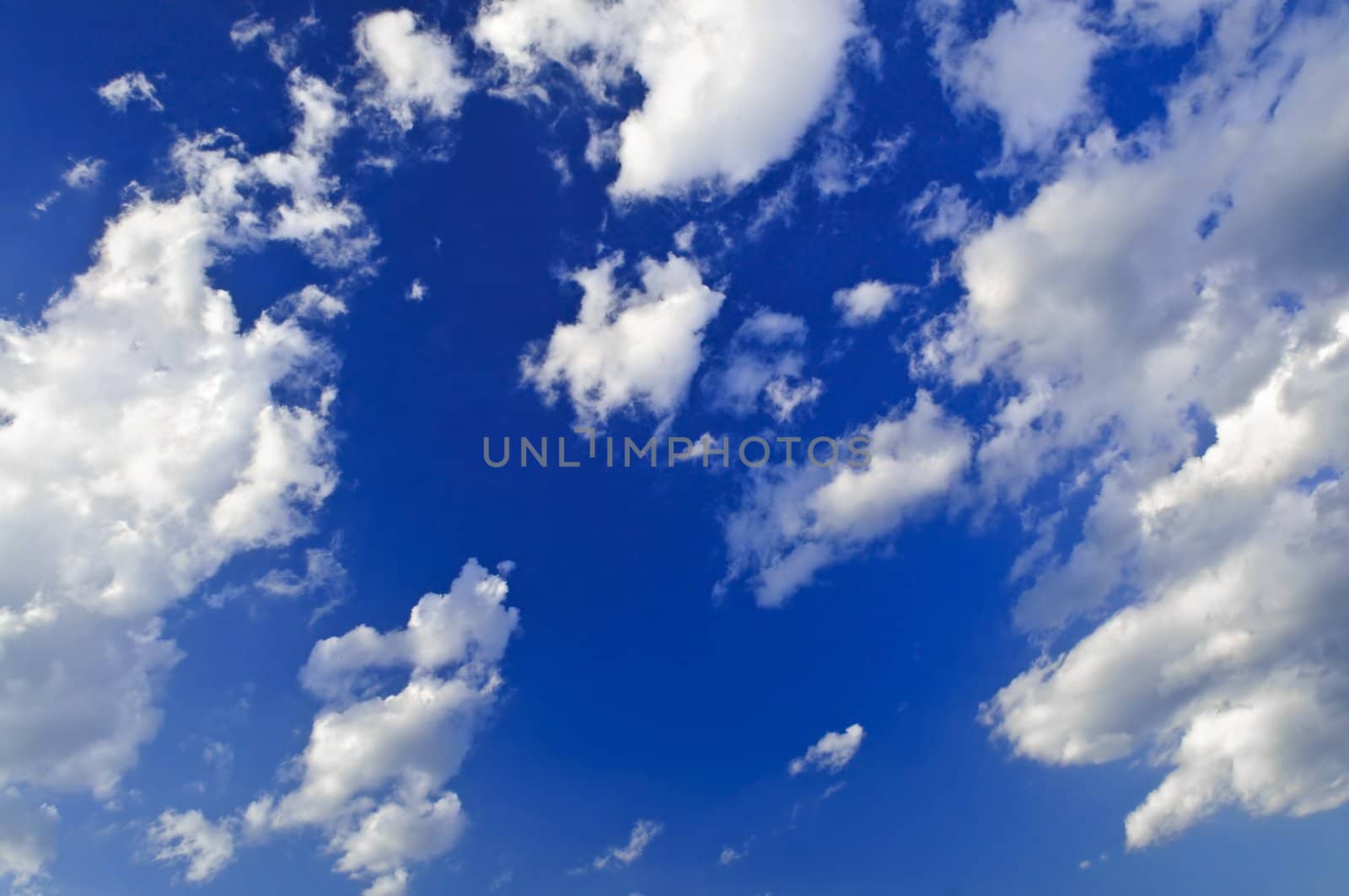 Background of blue sky with white cumulus clouds
