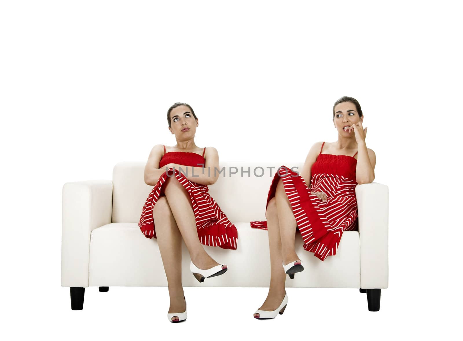 Two twin sisters seated on a couch upset with themselves - Picture collage of the same woman in diferent poses
