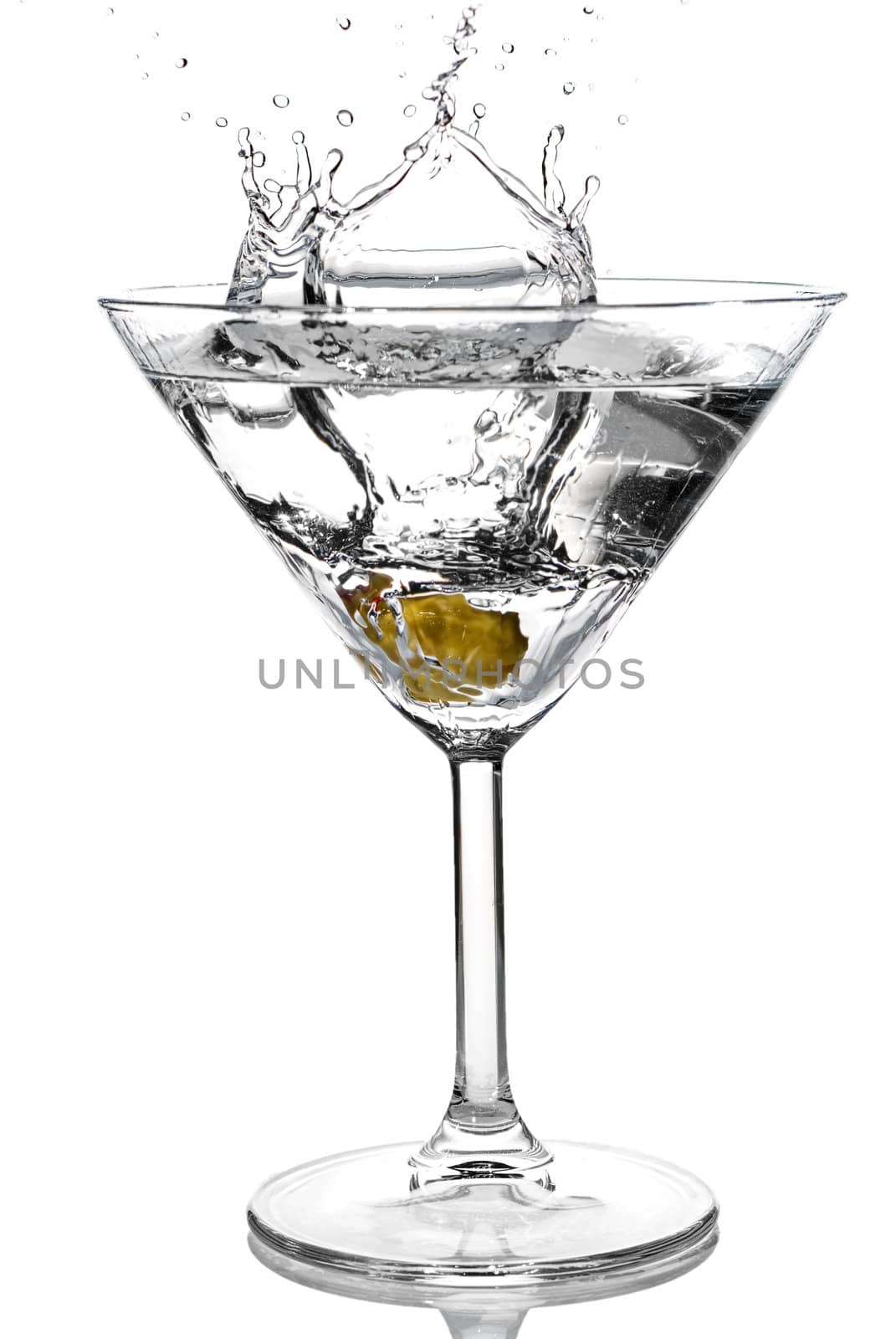 Olive splash into cocktail on white background