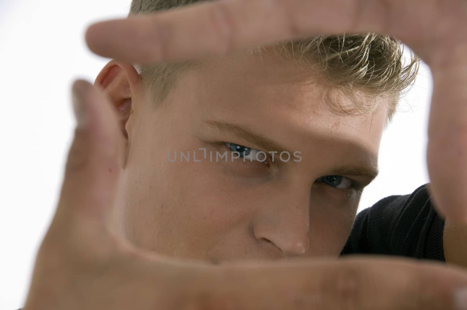 man showing framing hand gesture against white background