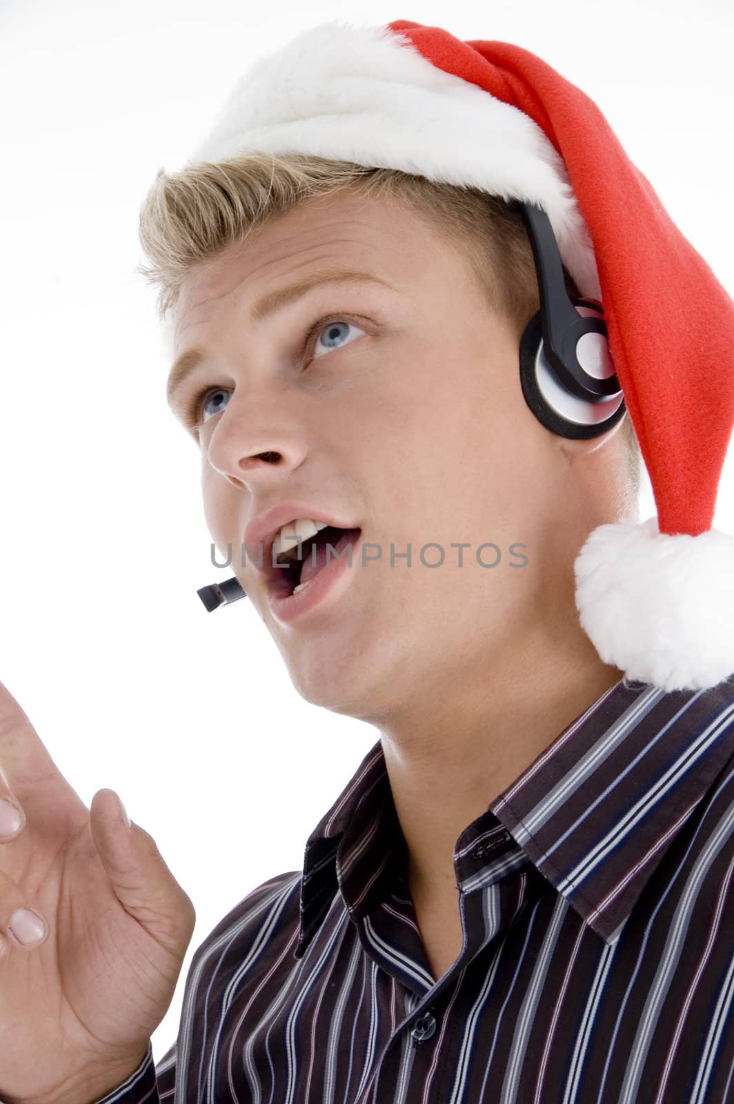close up of man interacting through headset wearing santa hat isolated with white  background