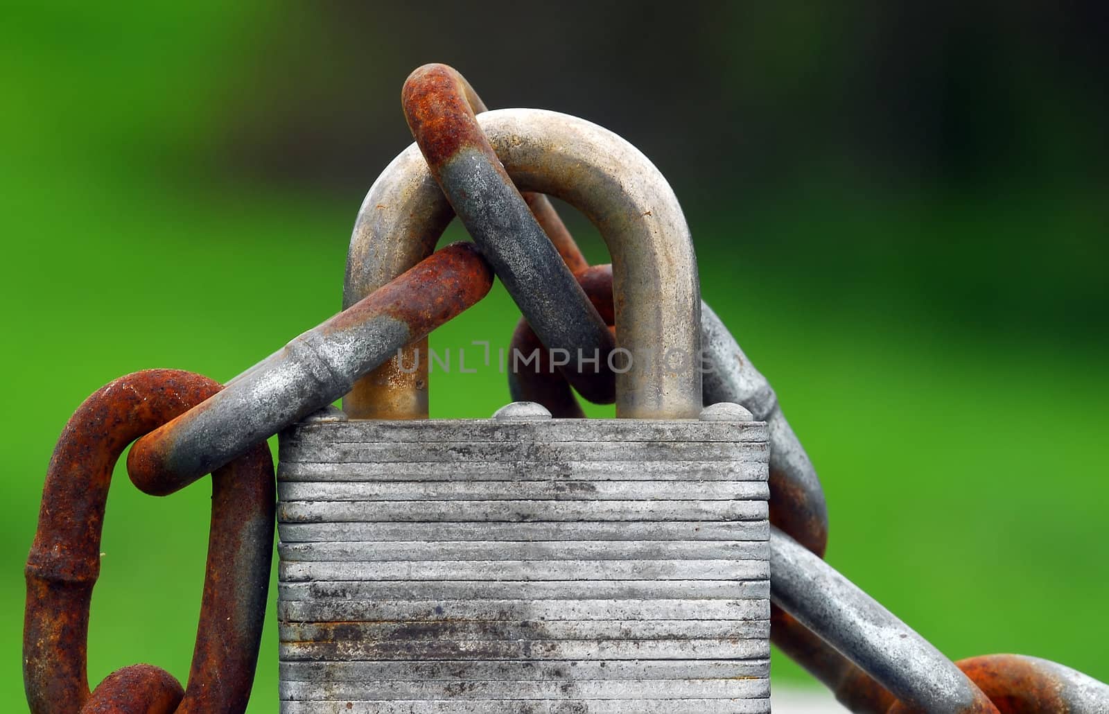 Close-up of a rusted padlock with a chain