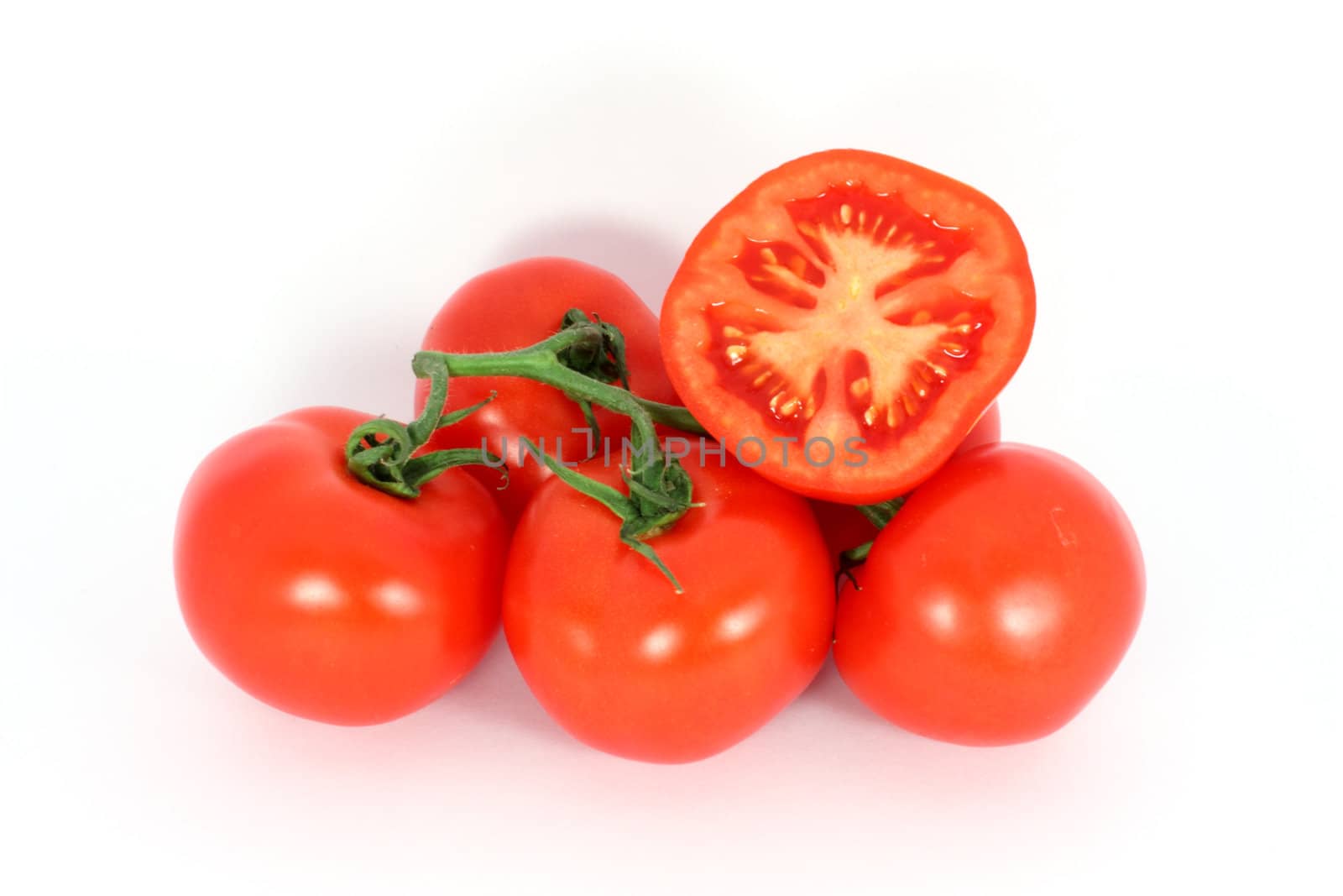 Red tomatoes on the branch isolated on white