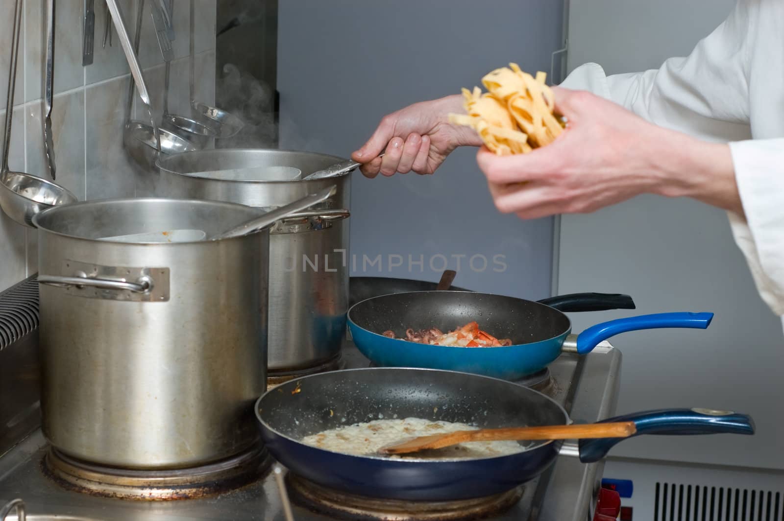 noodles and sauce preparation, interior of italian restaurant kitchen