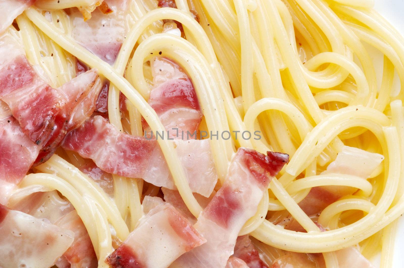 closeup of pasta carbonara, with fried fbacon