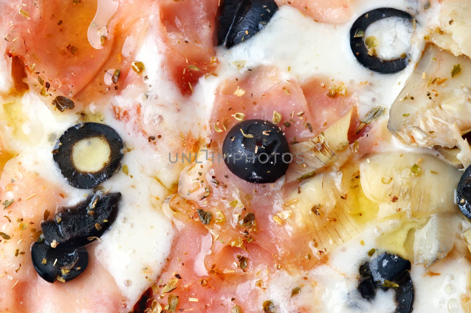 extreme closeup of italian pizza with bacon and artichokes