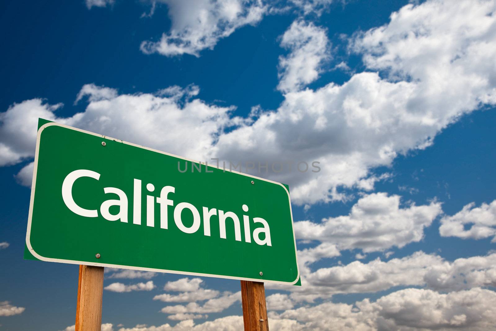 California Green Road Sign with Copy Room Over The Dramatic Clouds and Sky.