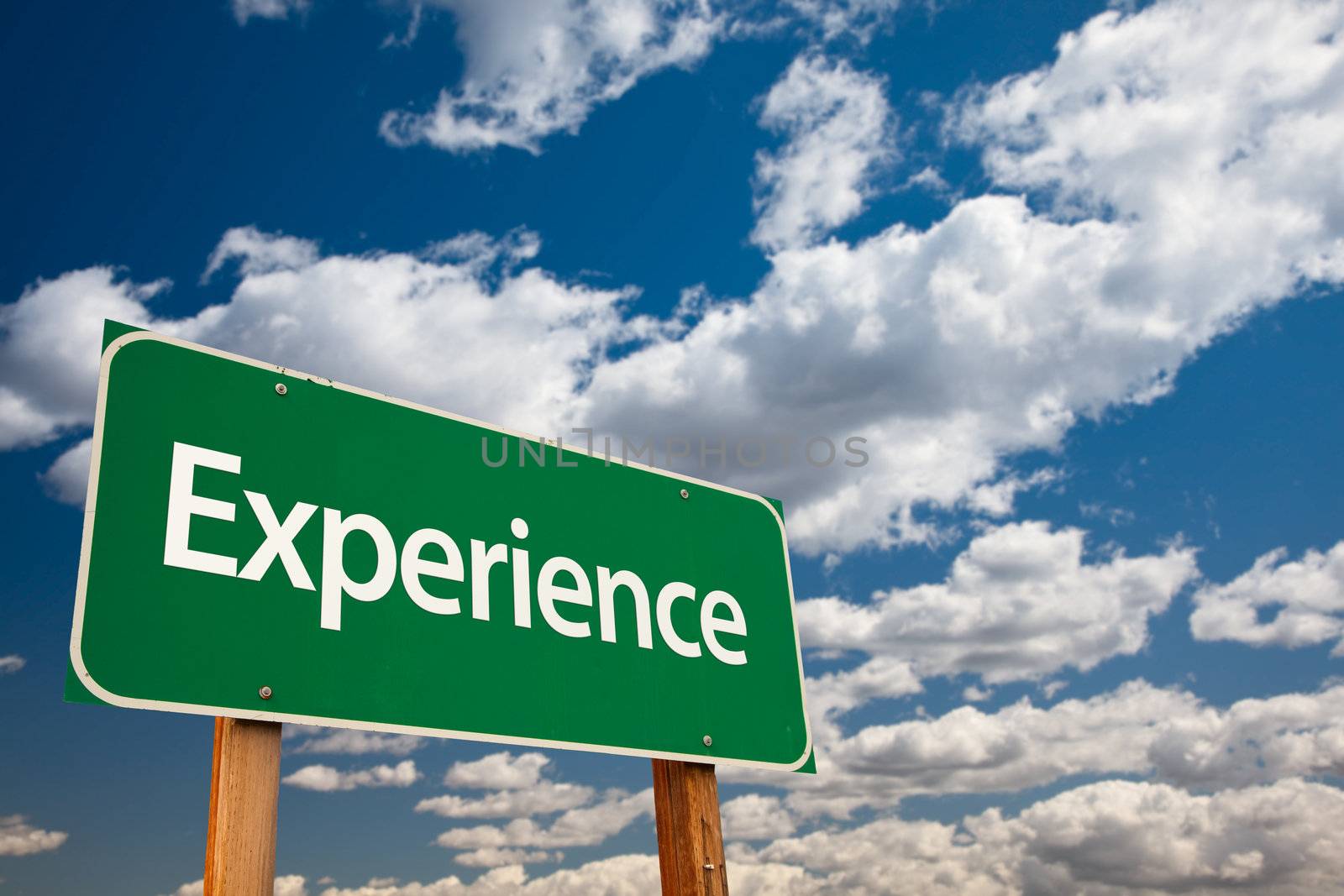 Experience Green Road Sign with Copy Room Over The Dramatic Clouds and Sky.