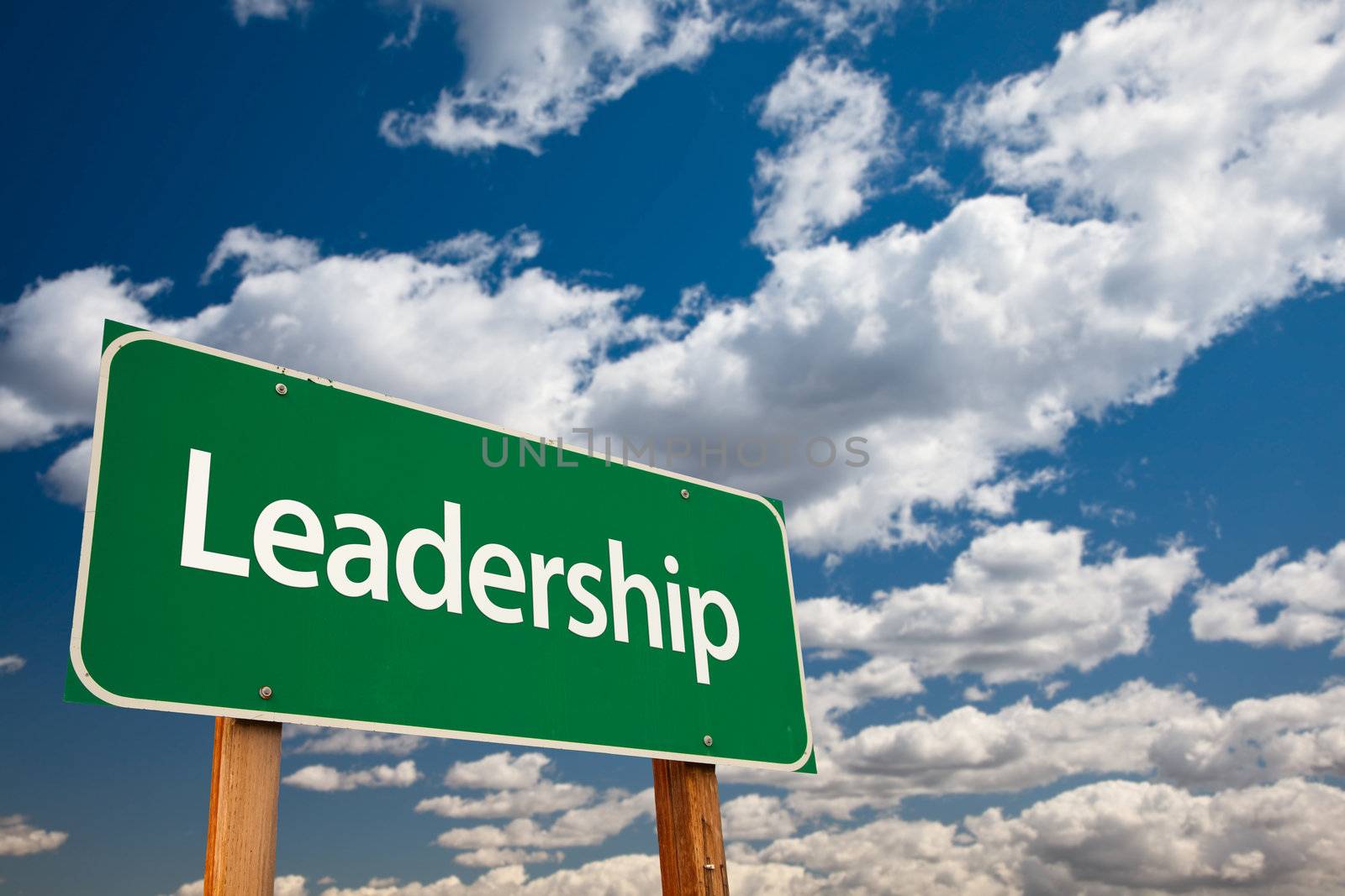 Leadership Green Road Sign with Copy Room Over The Dramatic Clouds and Sky.