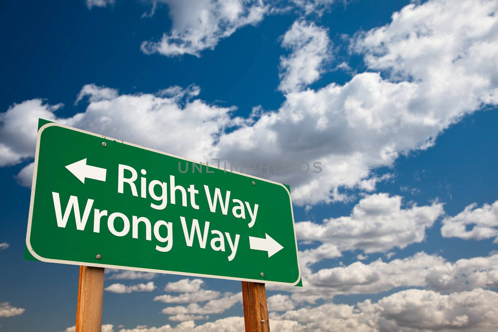 Right Way, Wrong Way Green Road Sign with Copy Room Over The Dramatic Clouds and Sky.
