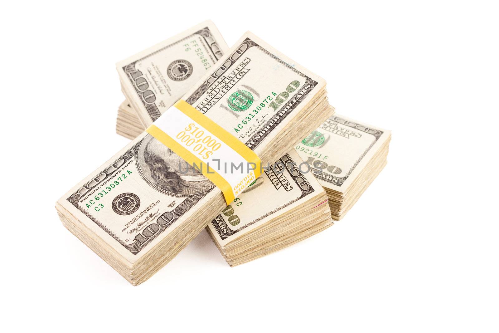 Stacks of Ten Thousand Dollar Piles of One Hundred Dollar Bills Isolated on a White Background.