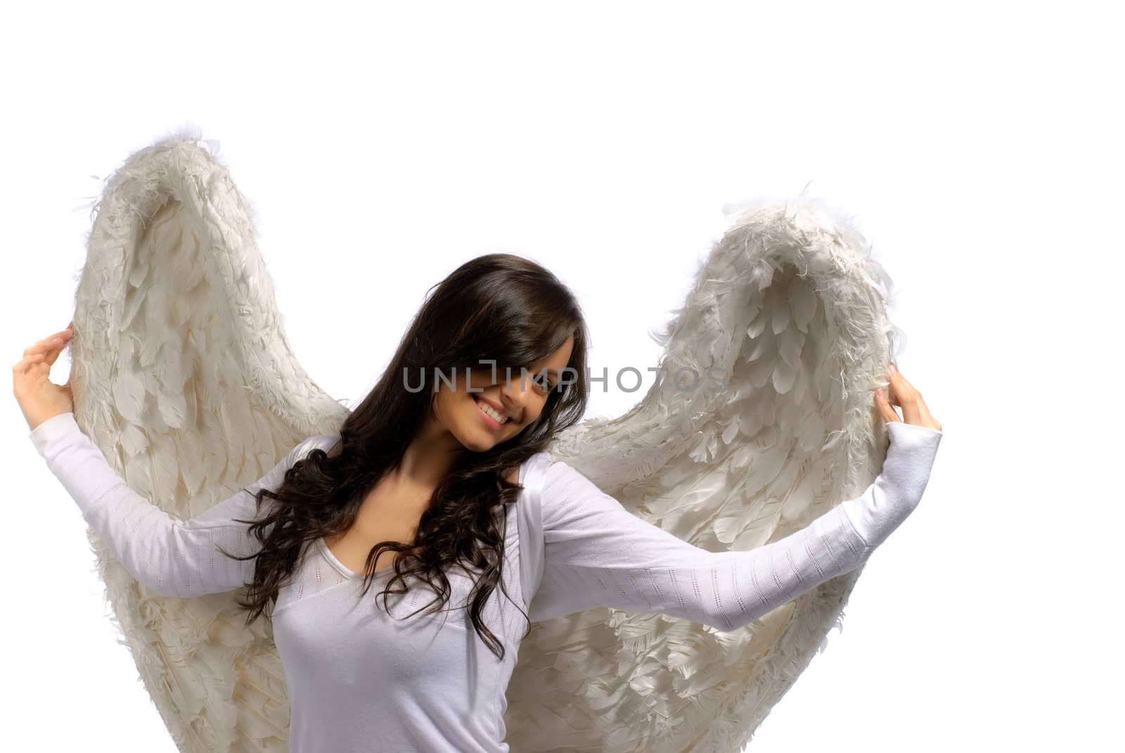 Young woman proudly holding her angel wings isolated on white