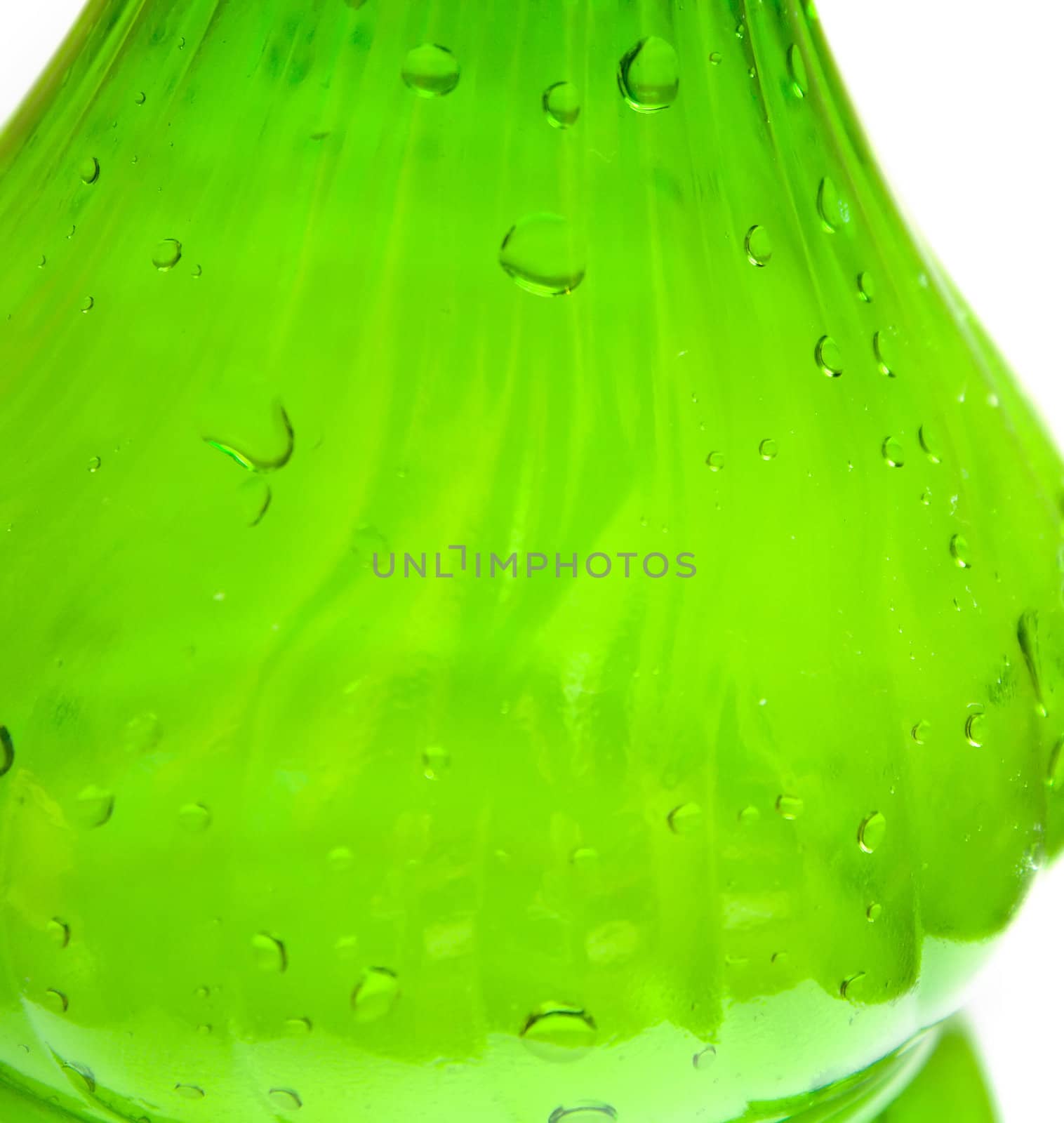Green plastic bottle with water on white. A background, macro