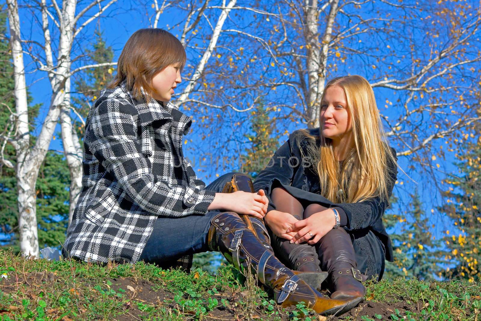 Two girlfriends against autumn nature