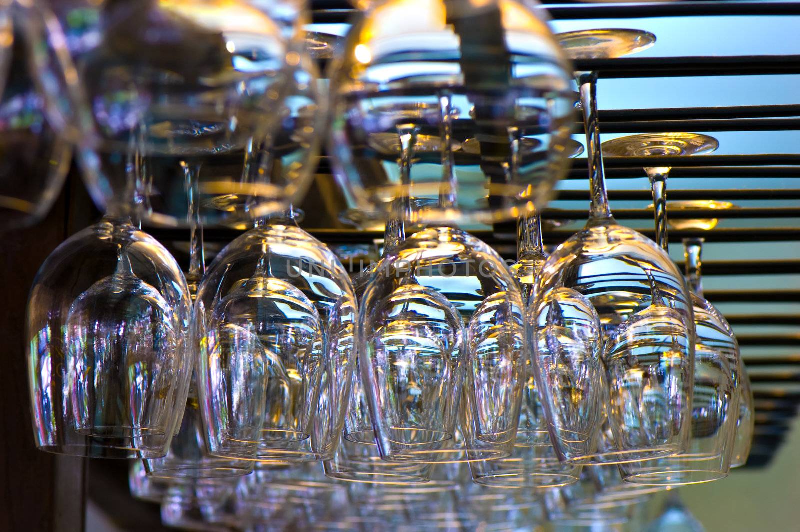 hanging wineglasses, selective focus, lot of color reflecions and chromatic aberrations left intentionally