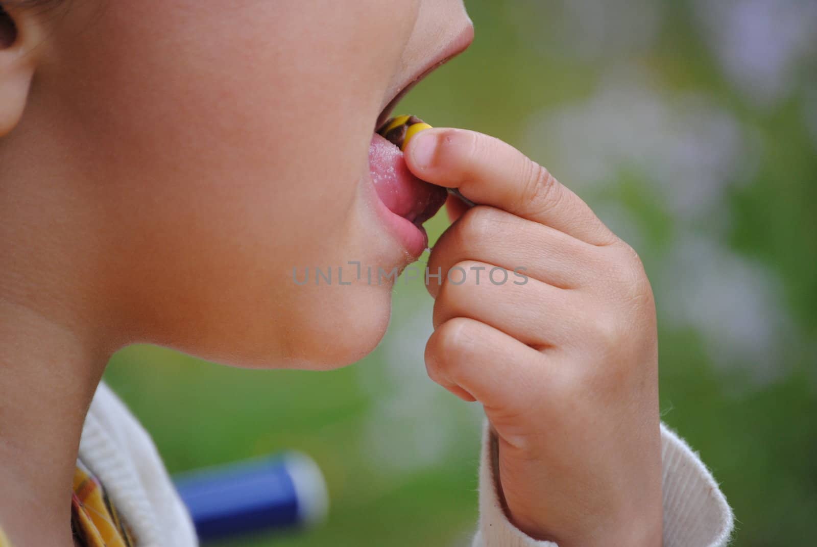 child closeup tasting a chocolate