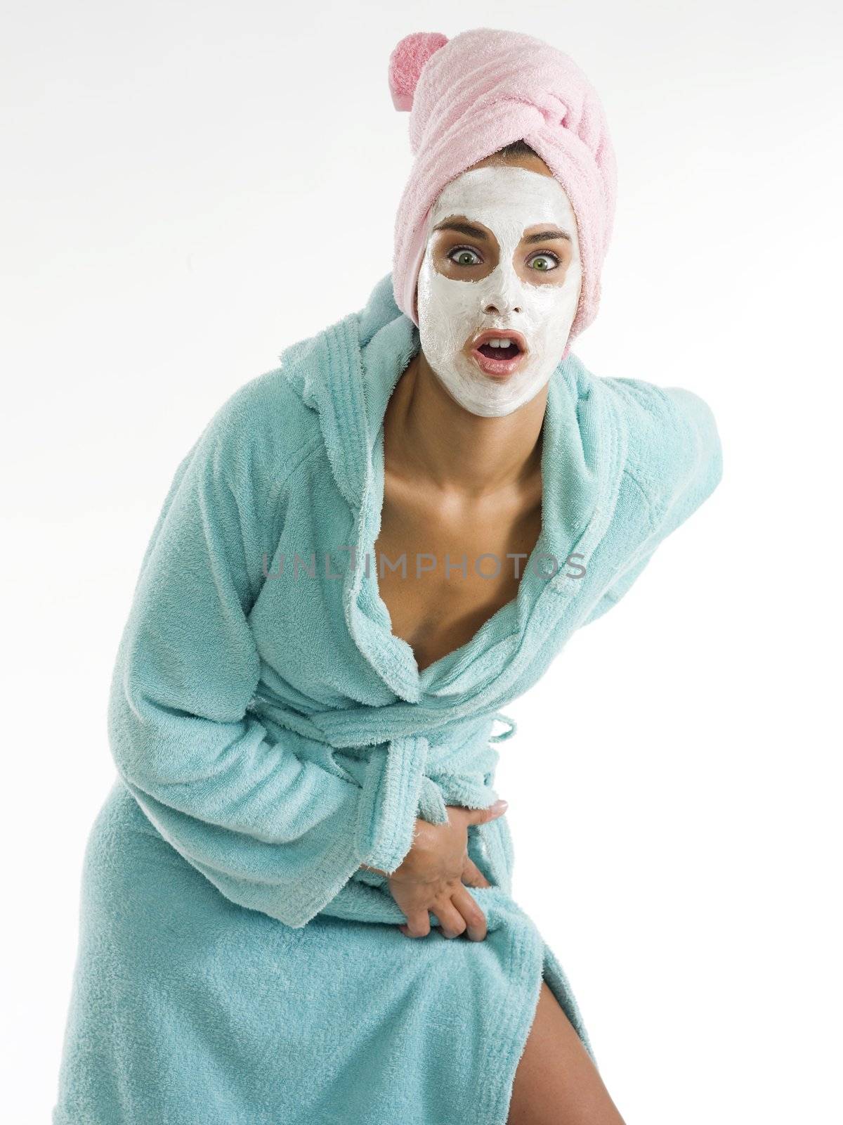 cute and nice girl with face cream mask looking in camera with surprise