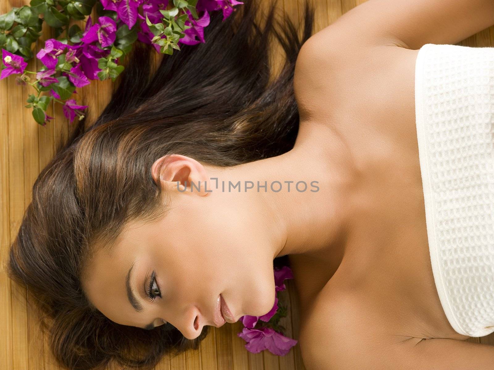 portrait of a beautiful brunette laying down on a wood carpet