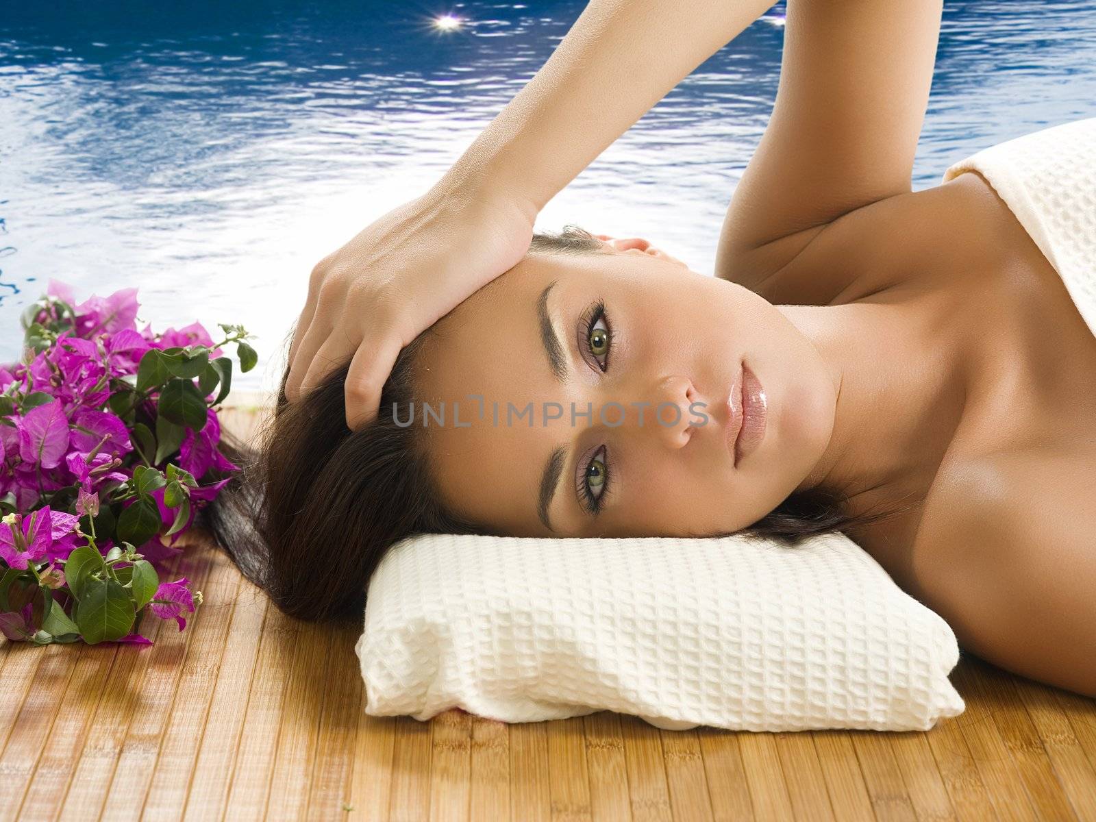 very cute brunette with wonderful eyes laying down on a carpet near a swiming pool