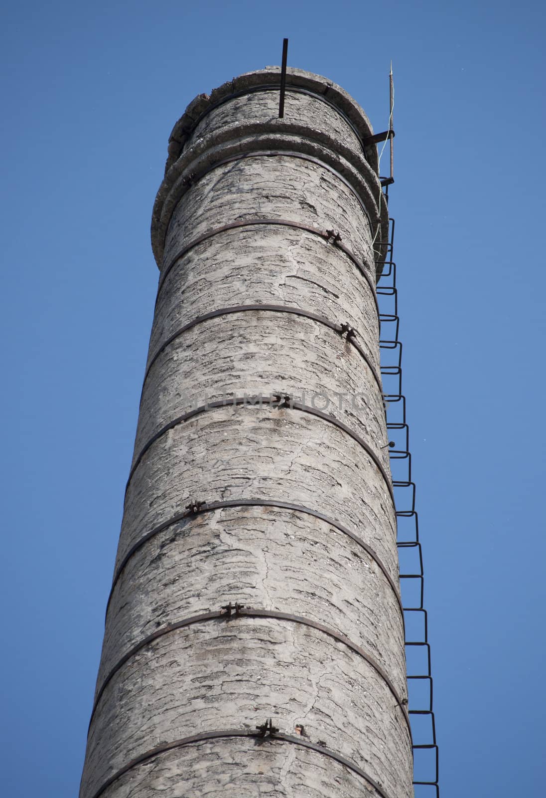 Italian Abandoned Factory chimney alone in the sky, with stairs