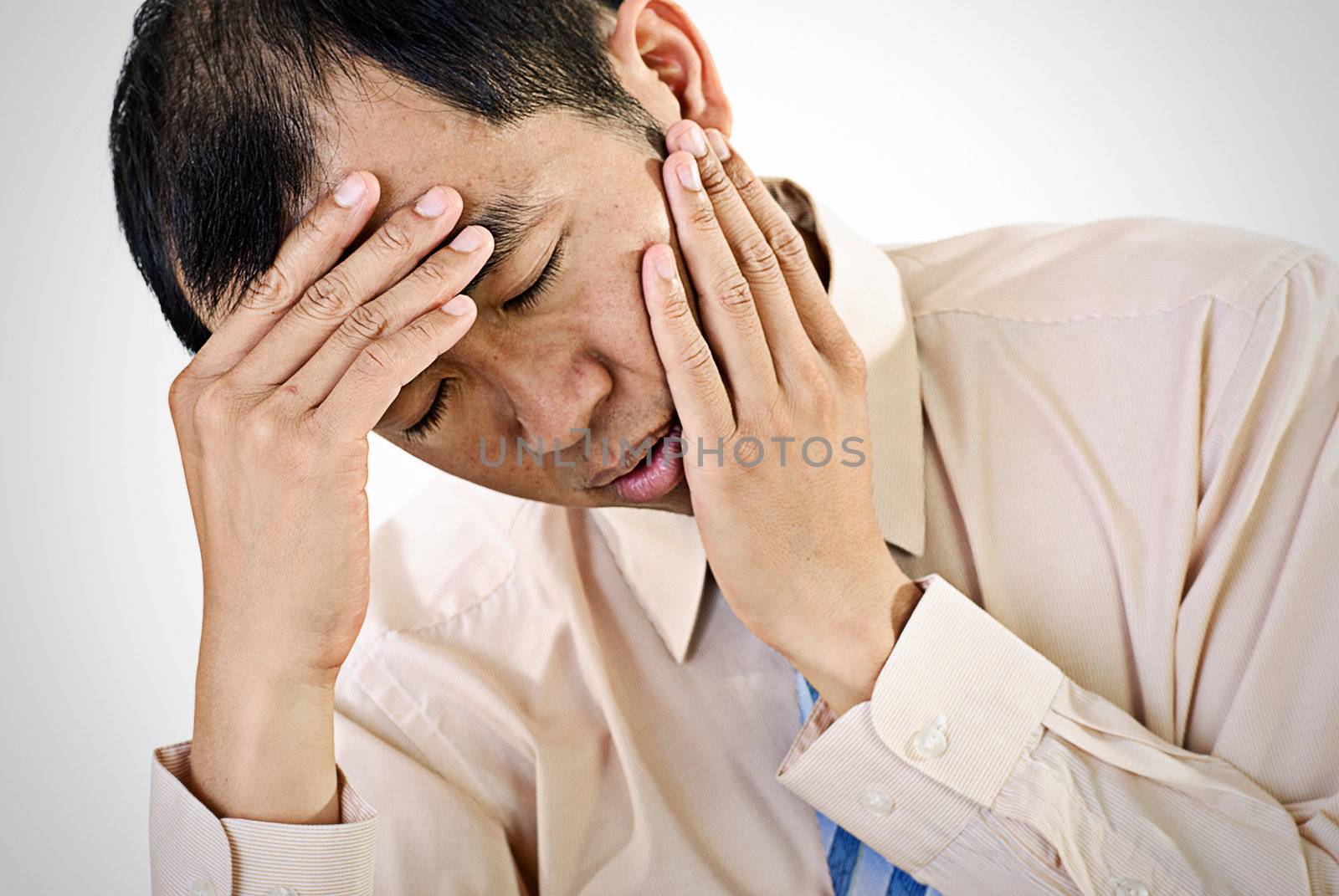 Sick businessman portrait of Asian with painful expression.