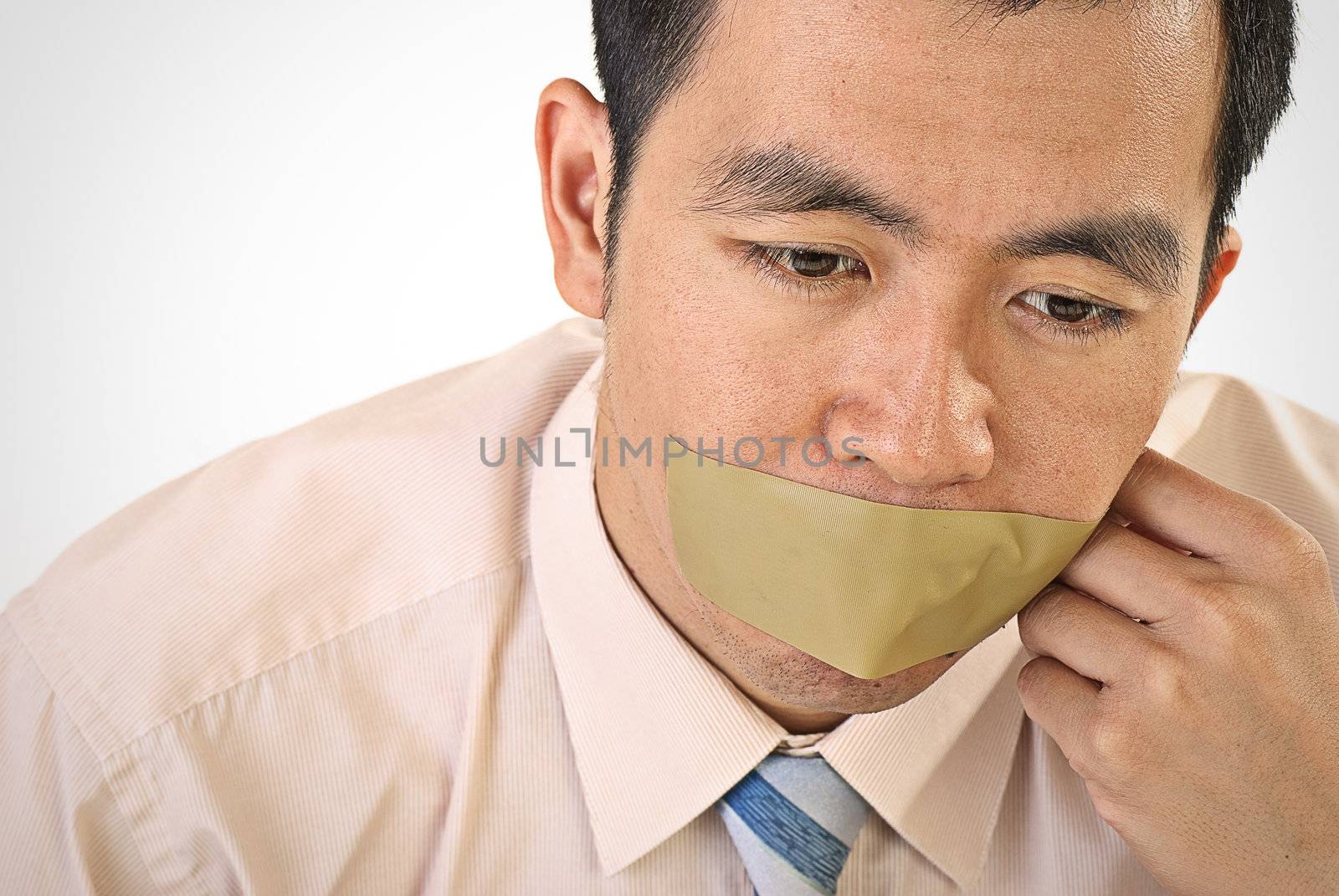 Silent businessman of Asian closeup portrait with tape on mouth.