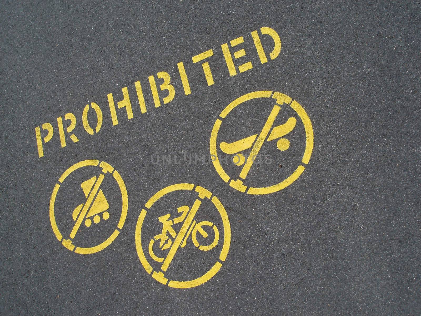 no cycling and skating sign stencilled on a pavement