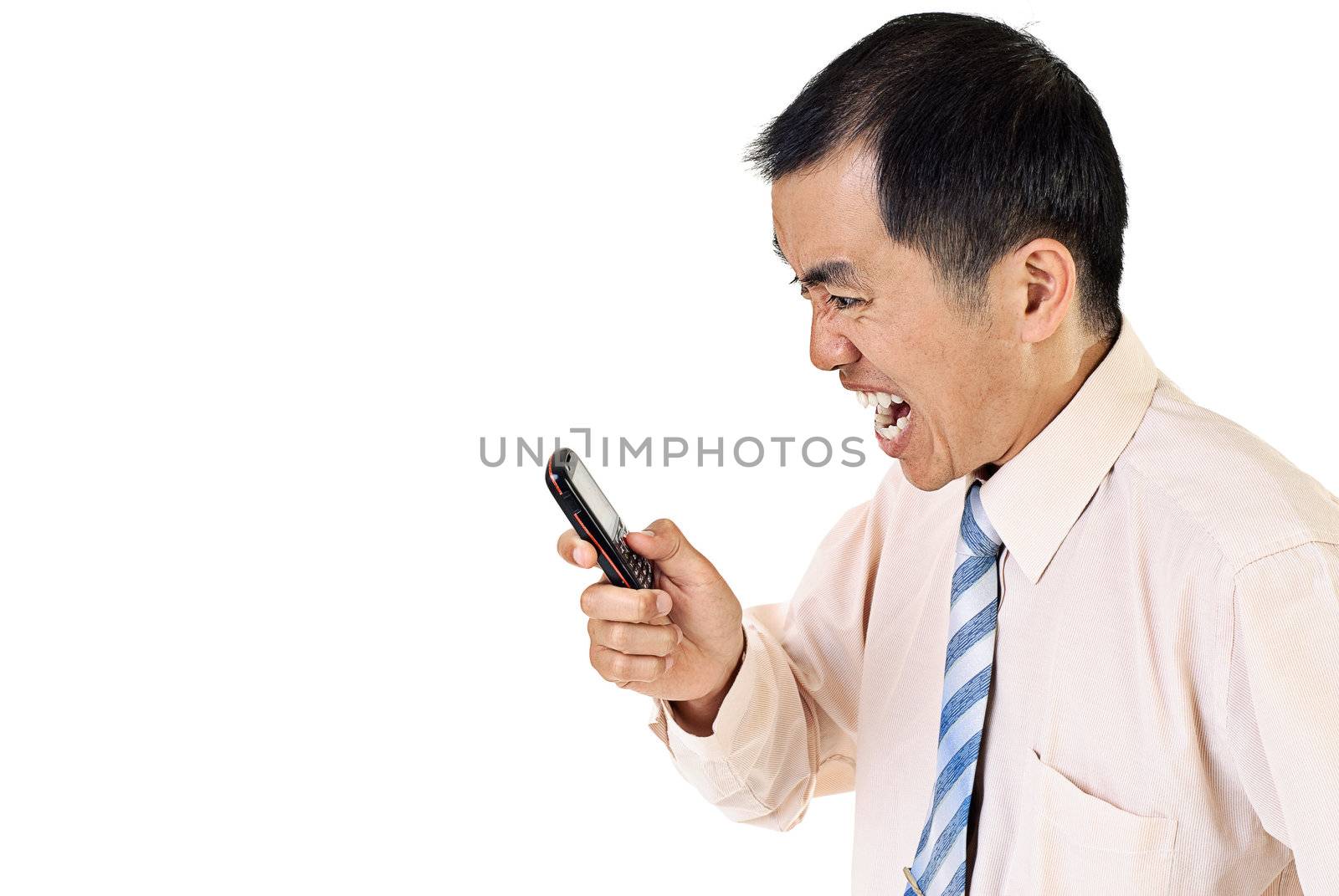 Angry businessman with cellphone on white background.