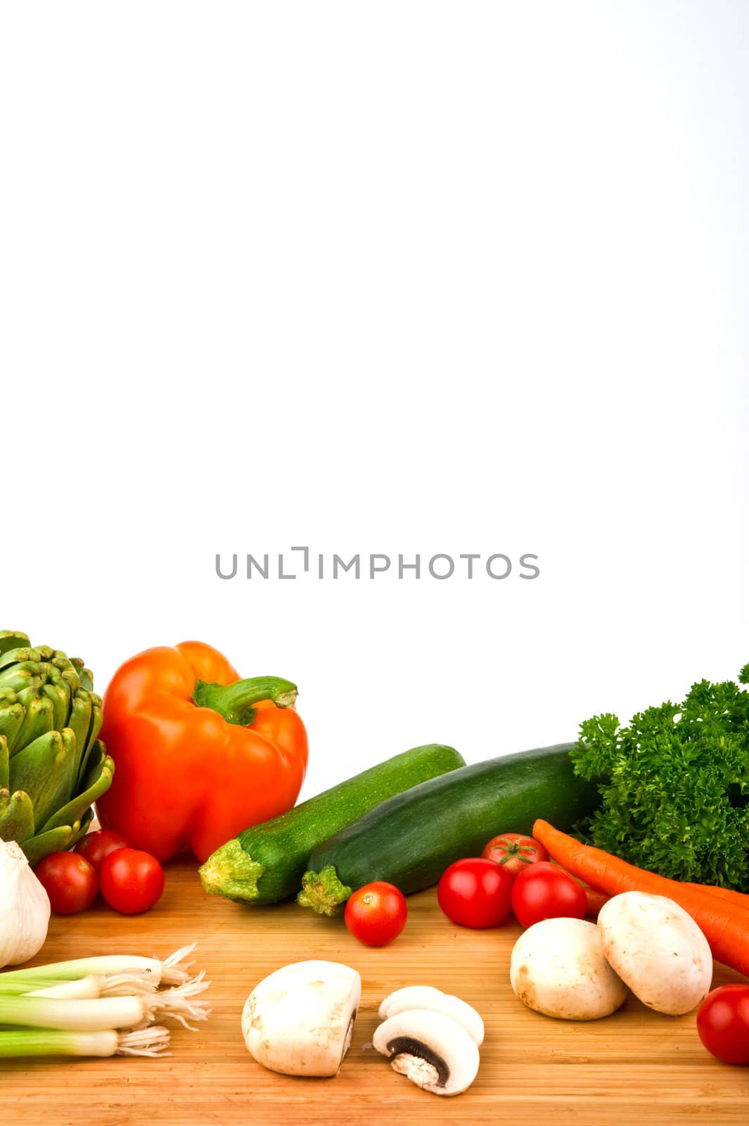 Image of a variety of colorful vegetables on a cutting board with a knife