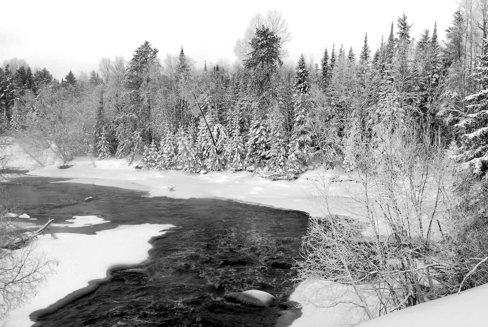 A landscape showing a frozen river in Winter