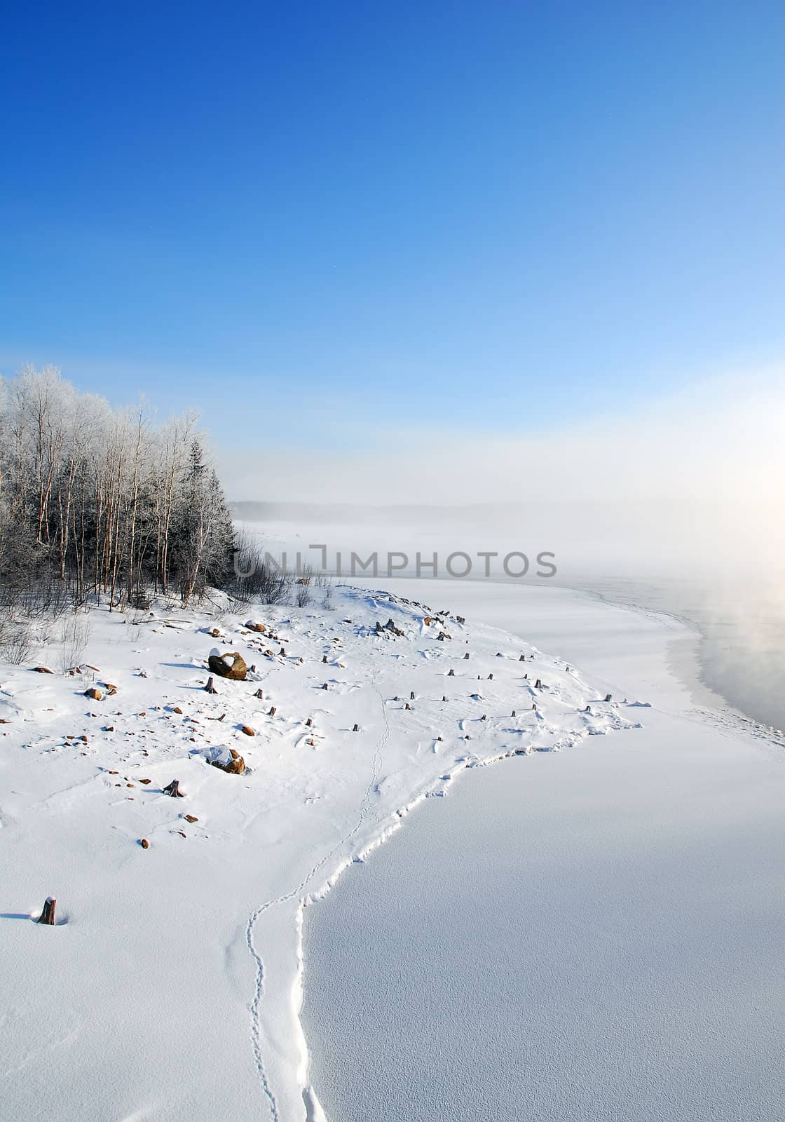 Winter landscape showing a frozen river on a very cold day