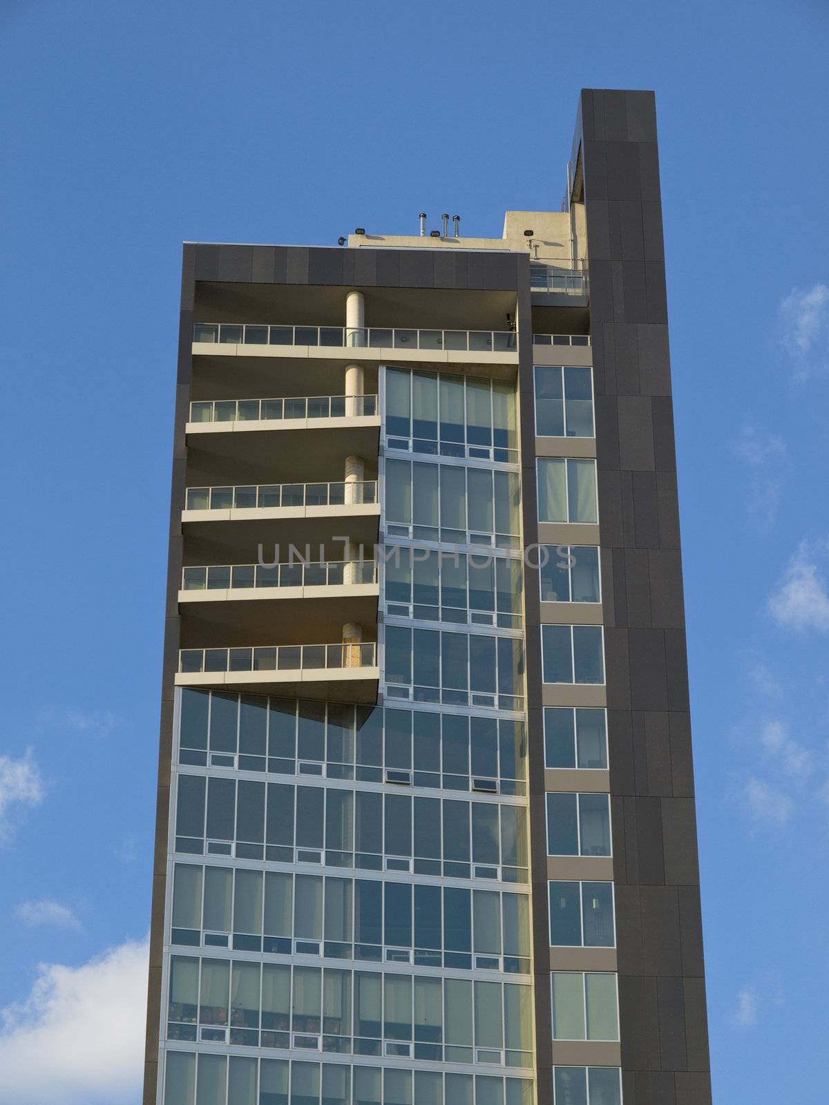 Modern west side loft building on blue sky background.