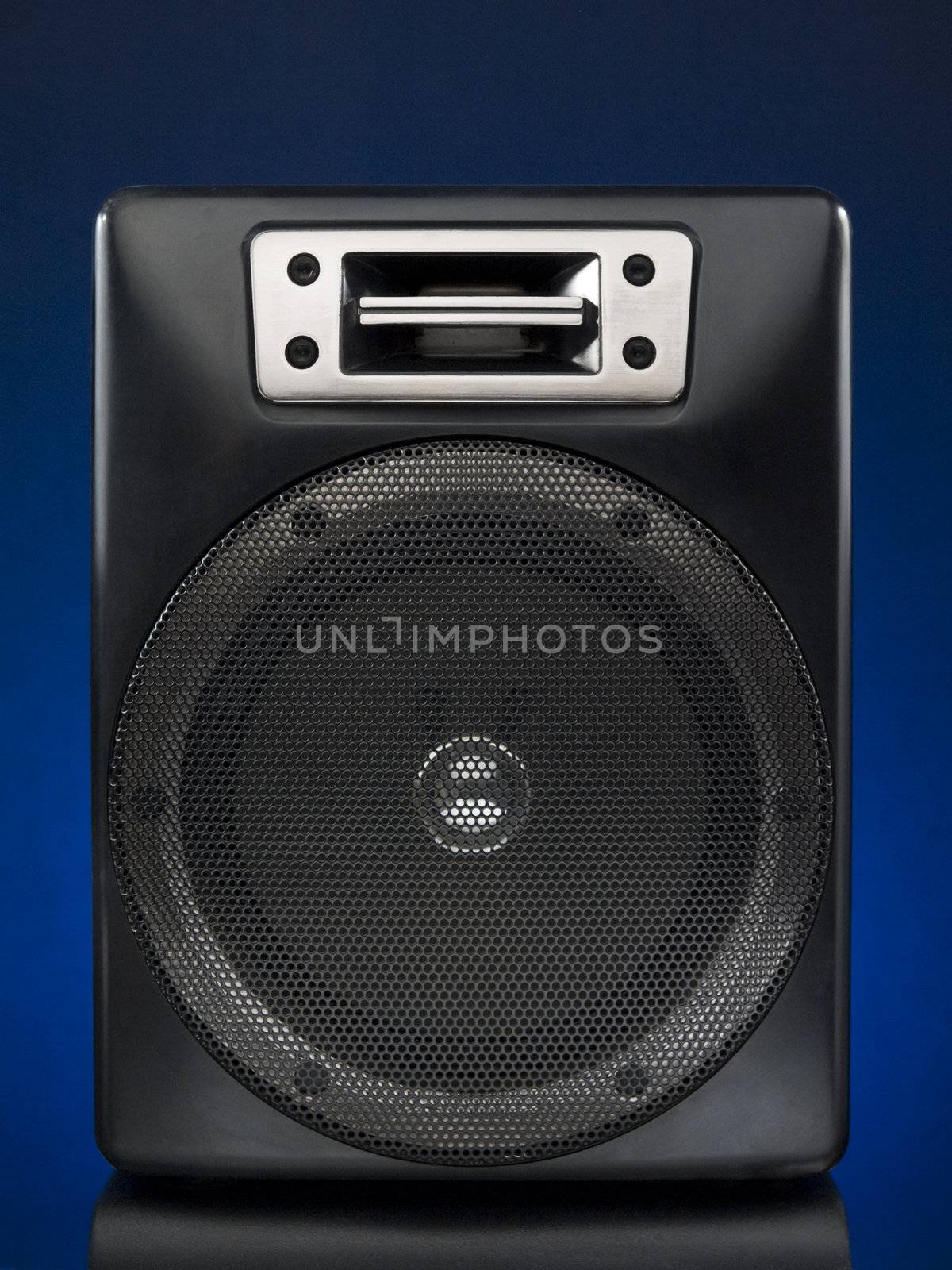 A black speaker over a blue background.