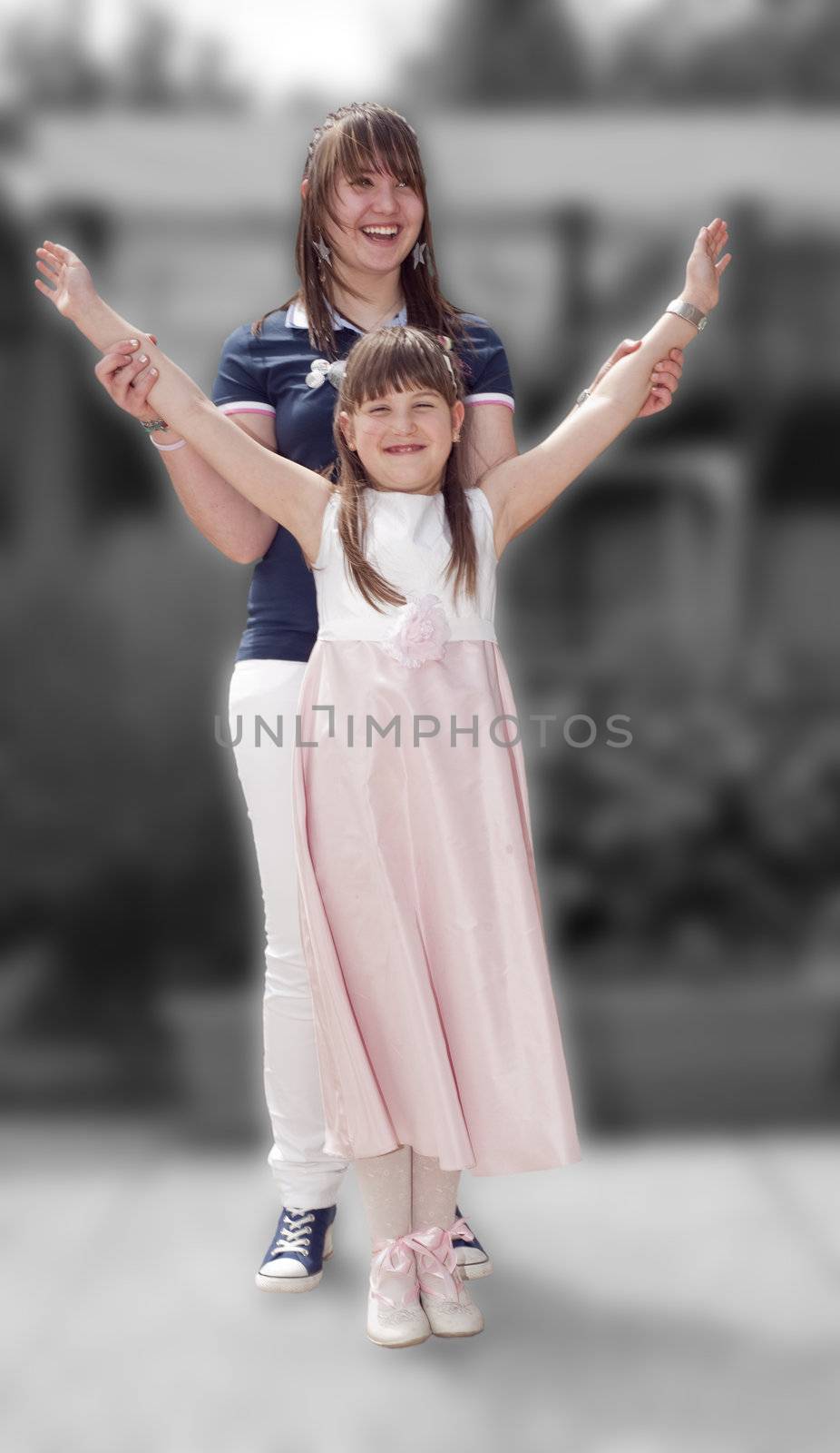 Two sisters joking on the day of First Communion