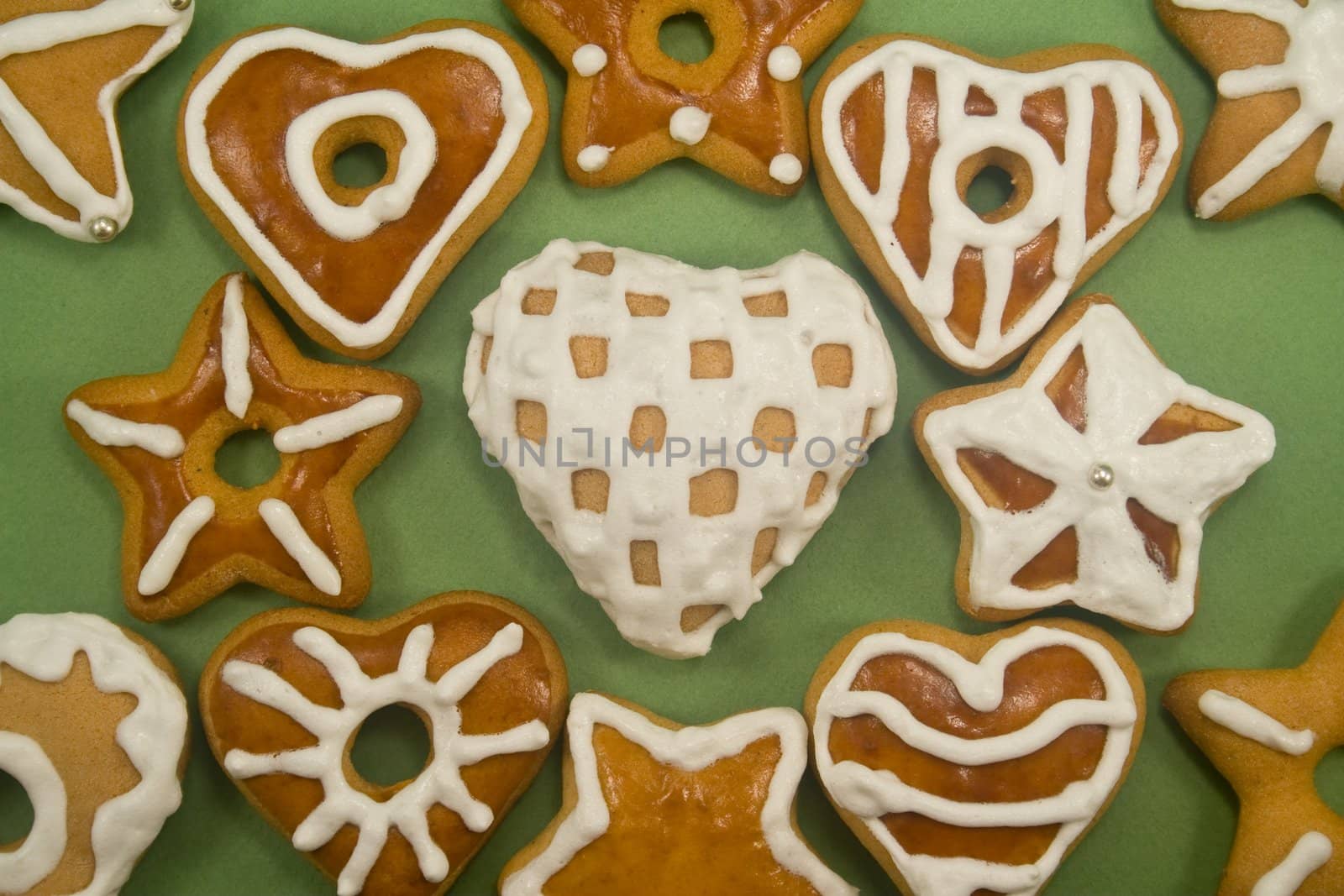 close-up of gingerbread cookies close together on green background