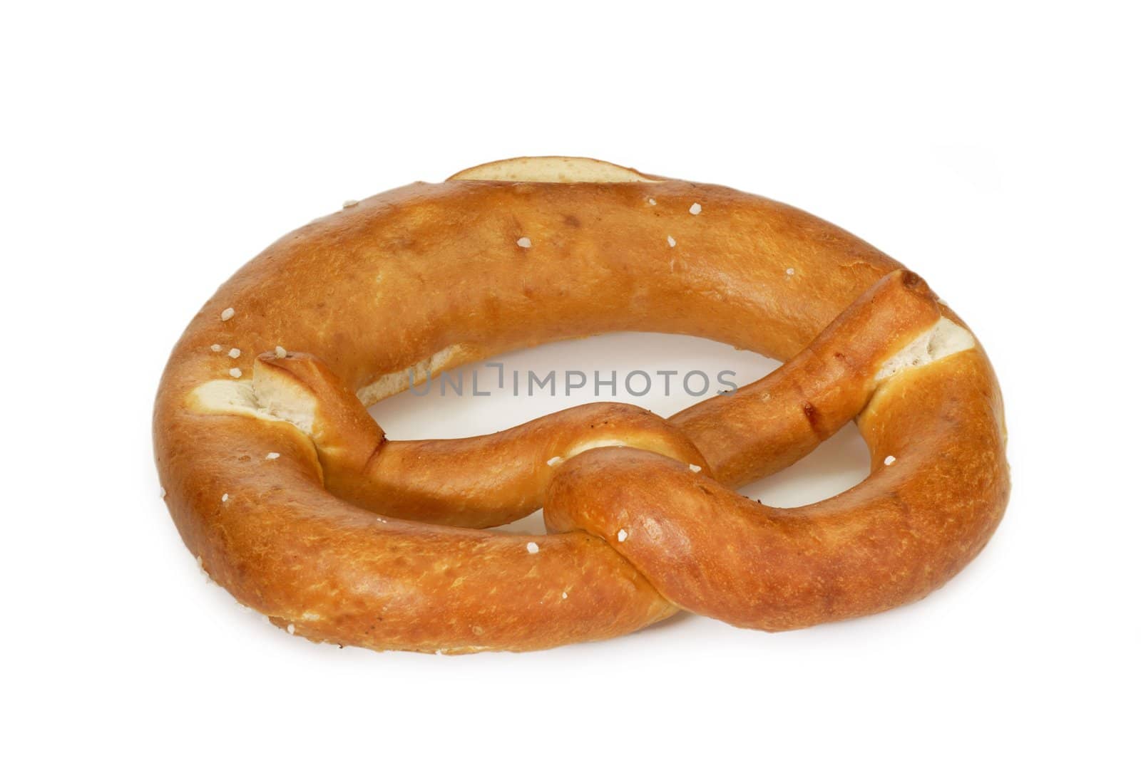 Salted pretzel on bright background.