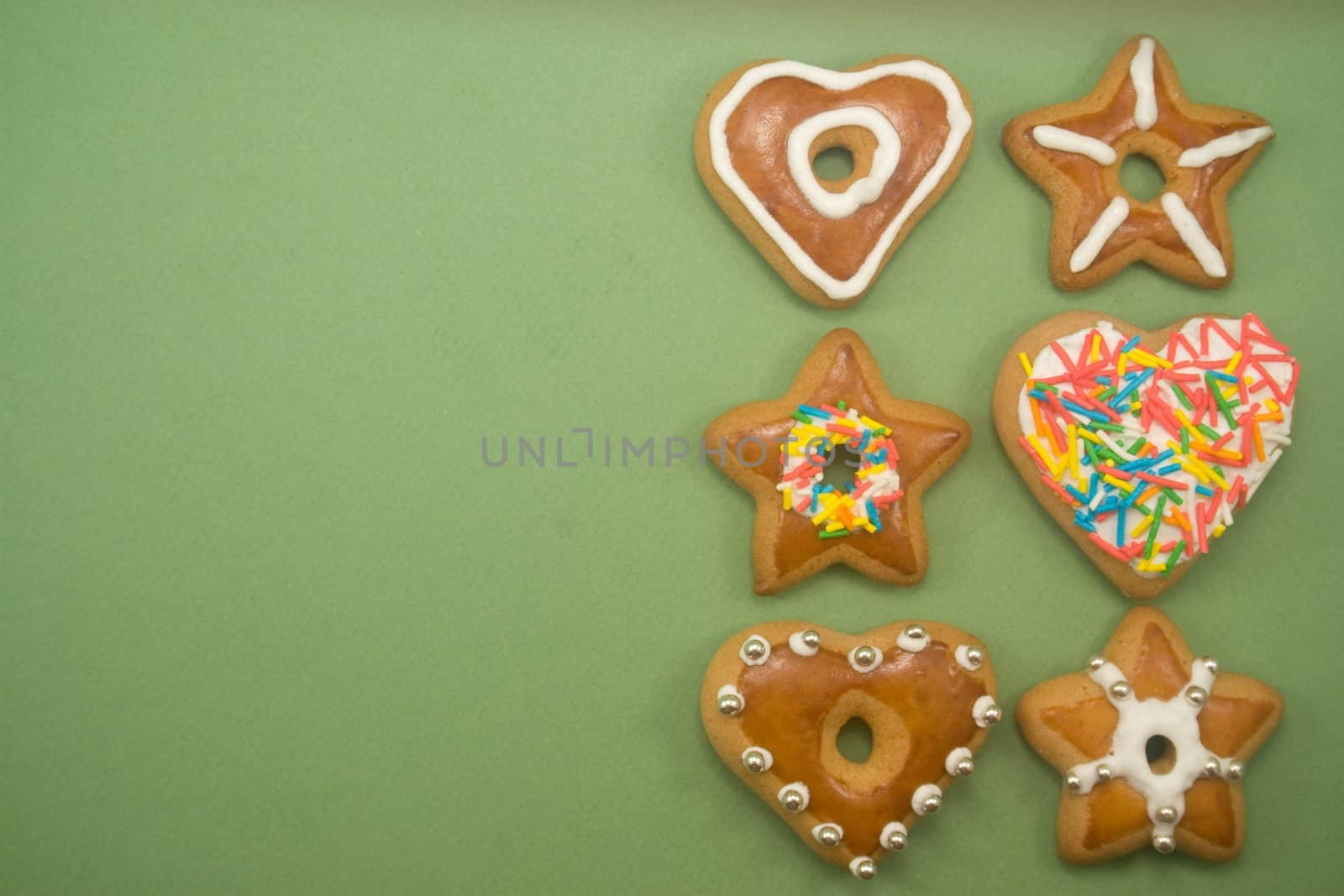 Six decorated gingerbread cookies on green with ad space on left