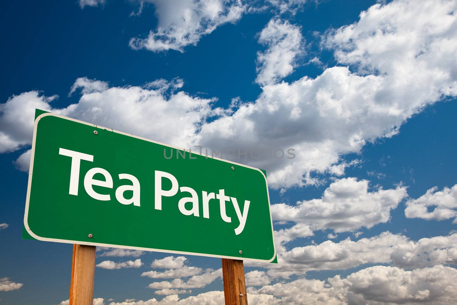 Tea Party Green Road Sign with Copy Room Over The Dramatic Clouds and Sky.