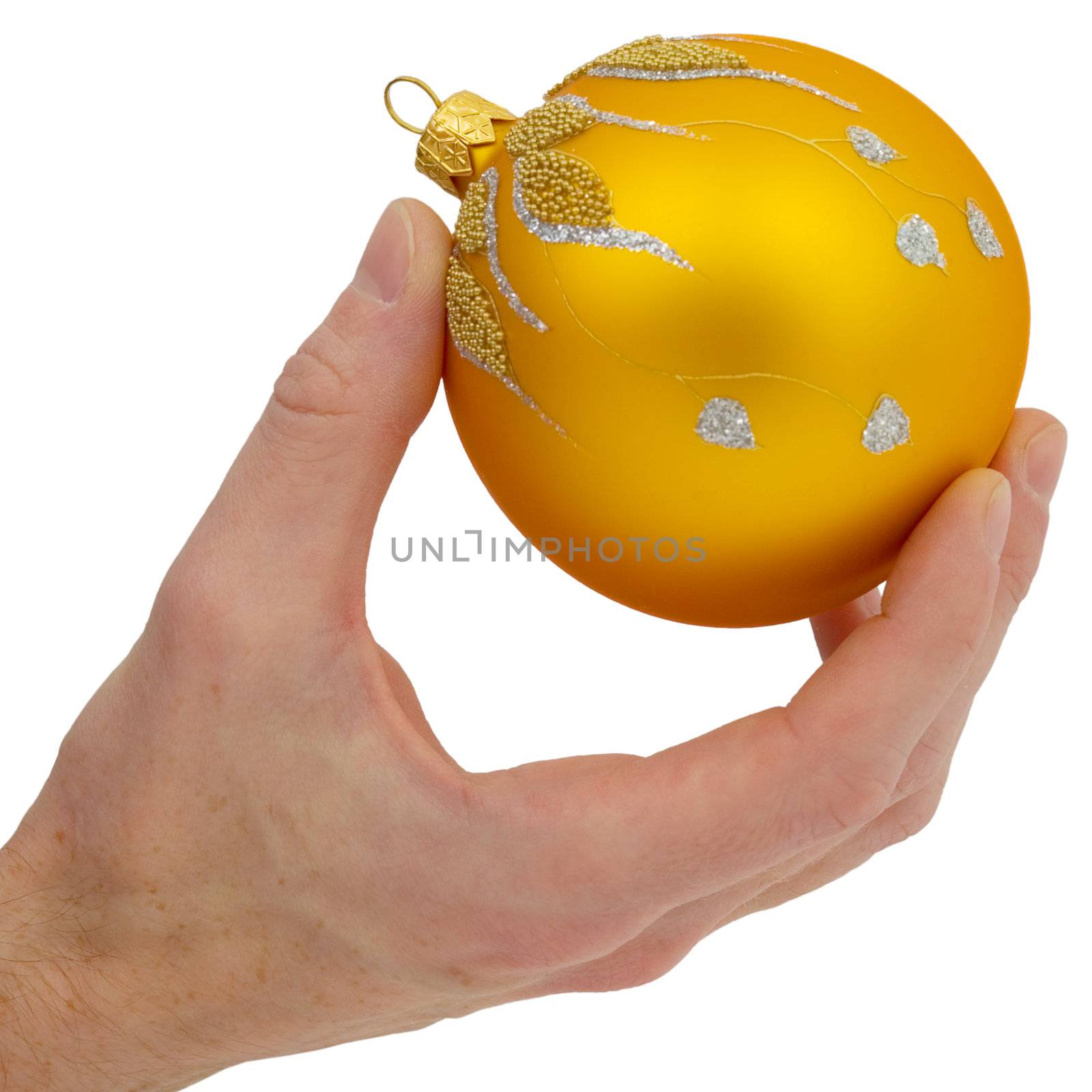Cristmas-tree golden ball in the hand on the white background
