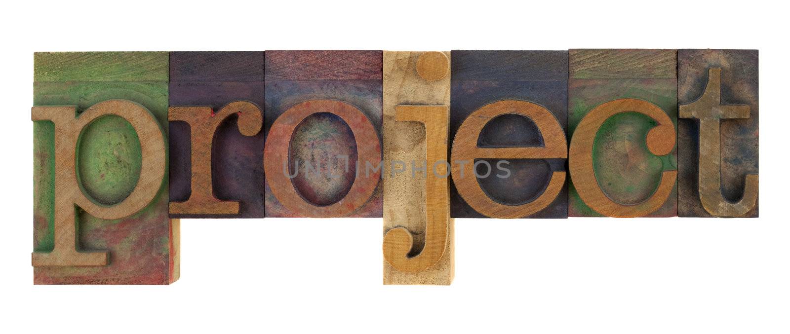 the word project in vintage letterpress type blocks, stained by color inks, isolated on white