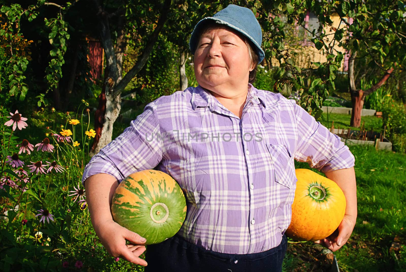 happy woman and two ripe pumpkin in garden