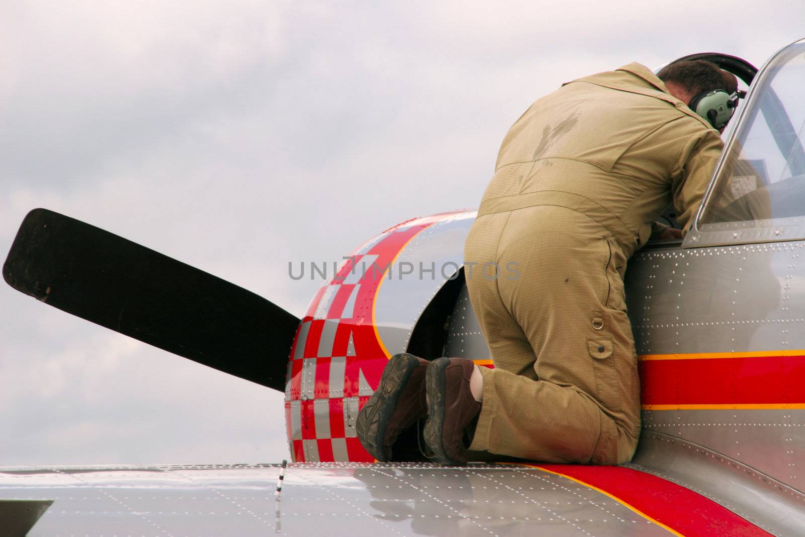 engineer performing final check on retro airplane before takeoff