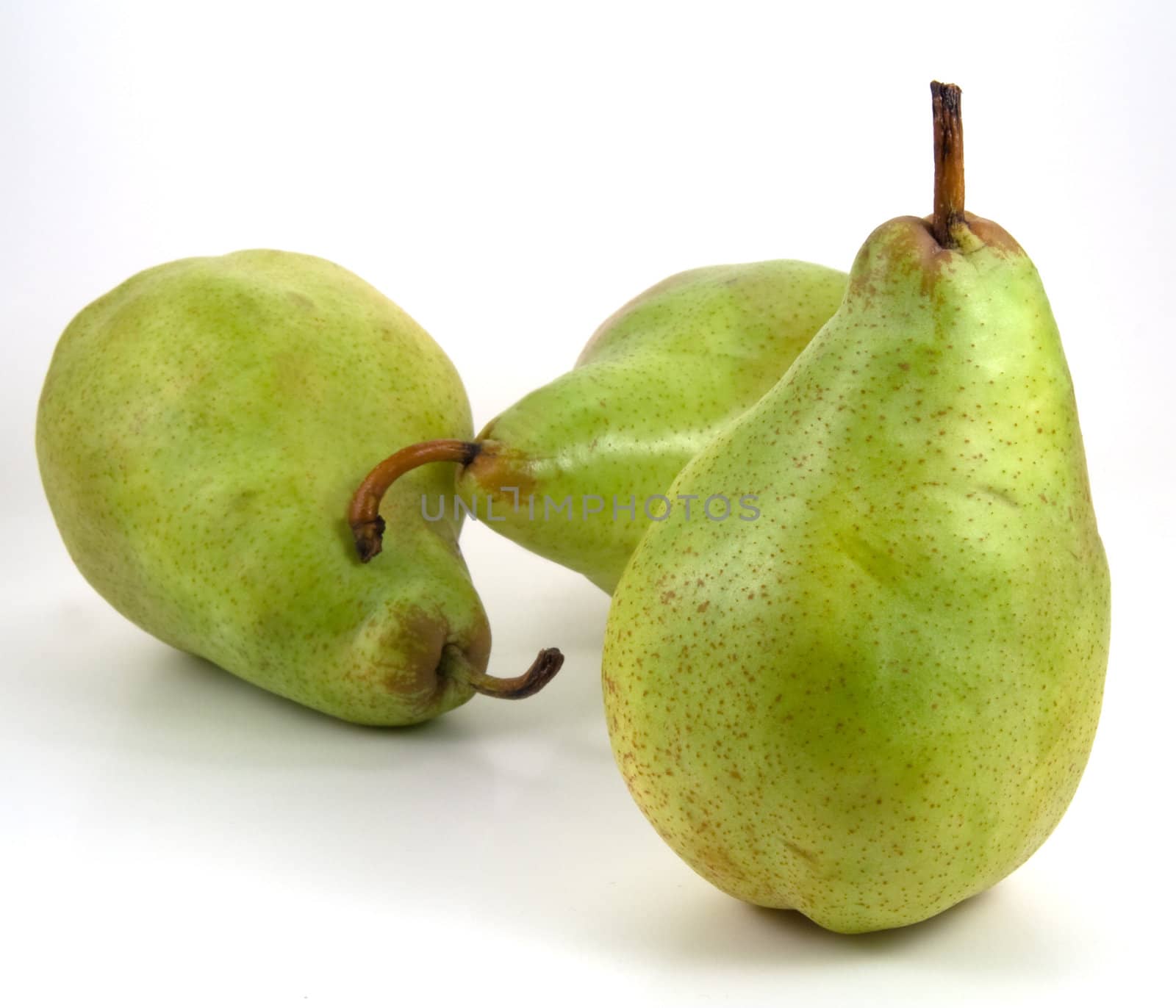 Three green pears on white background