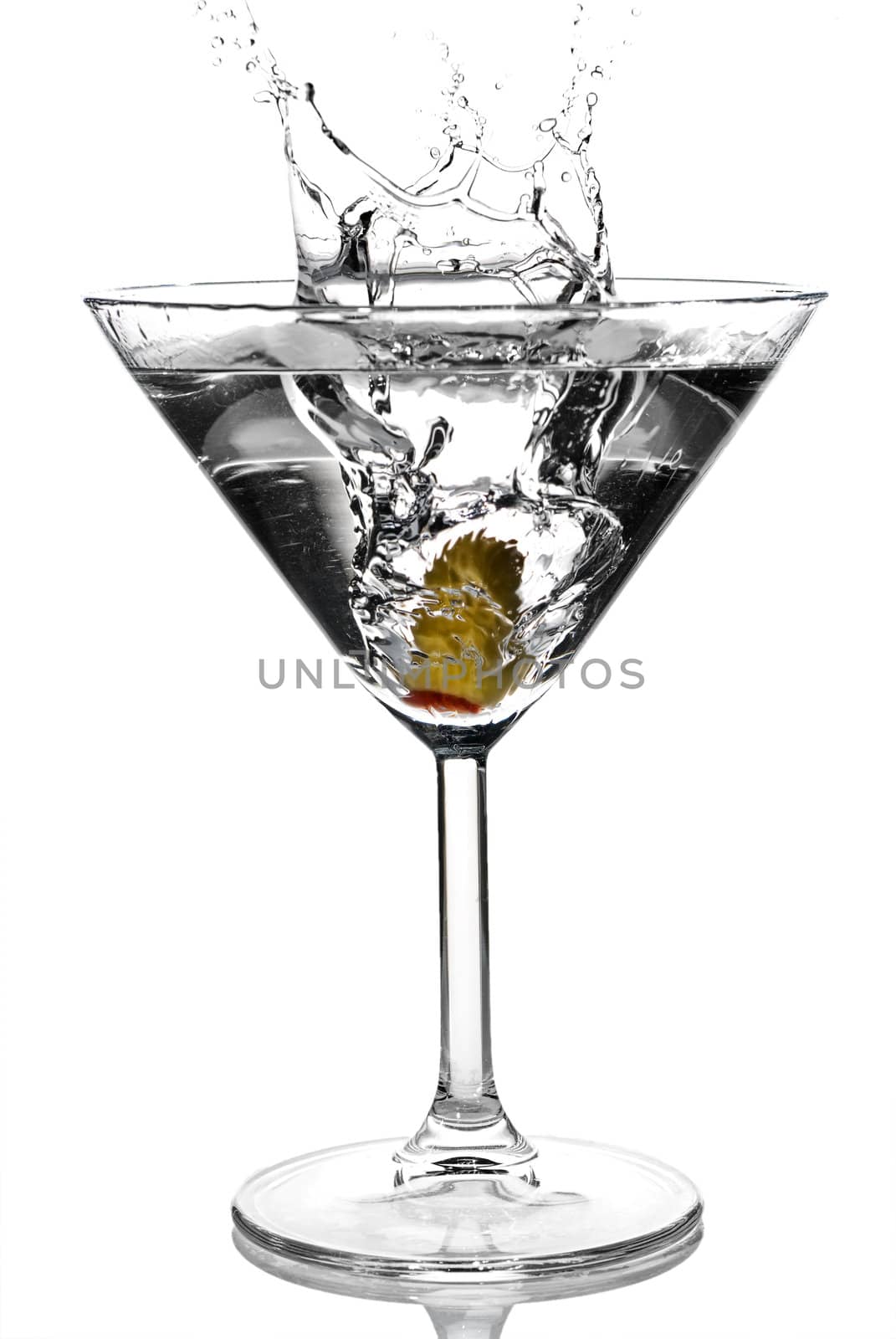 Olive splashing on martini isolated on white stock photo