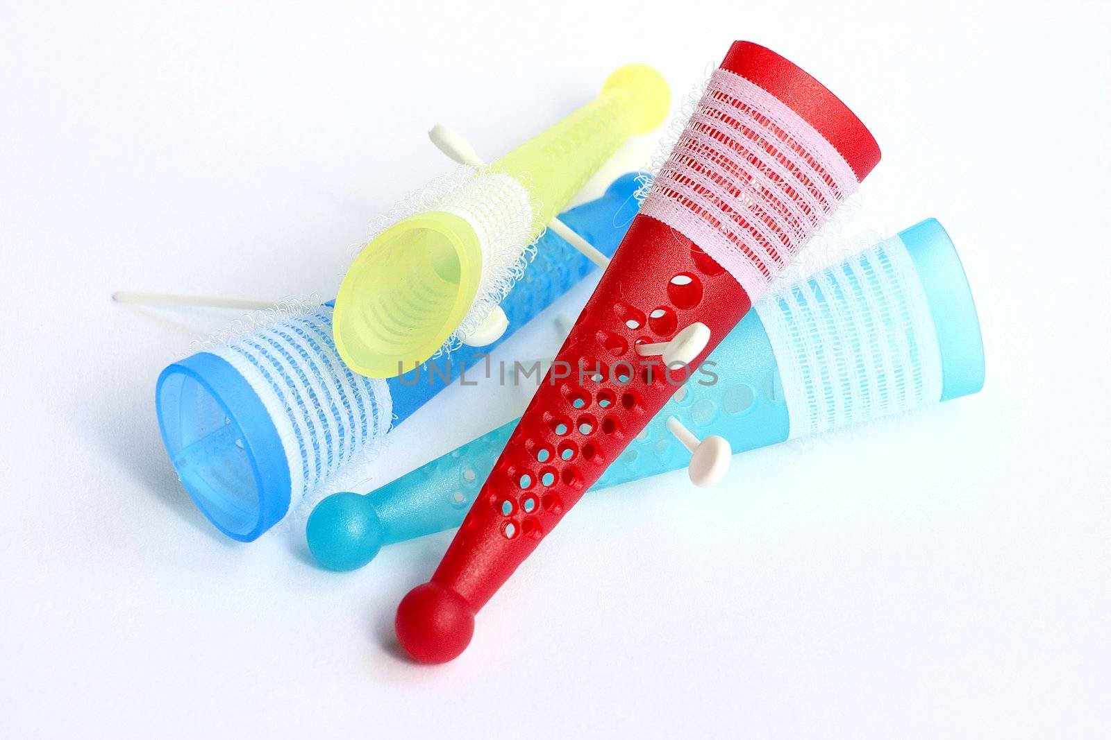 Colored hair rollers isolated on a white background