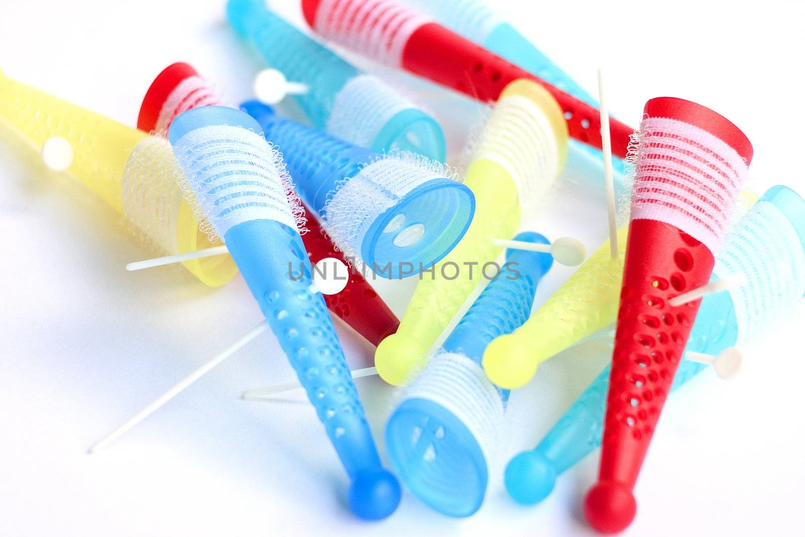Colored hair rollers isolated on a white background