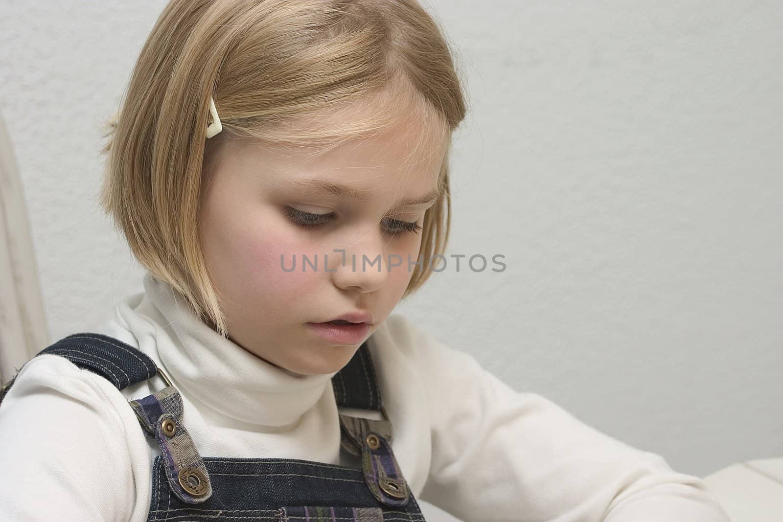 Child at the table arranges Jigsaws