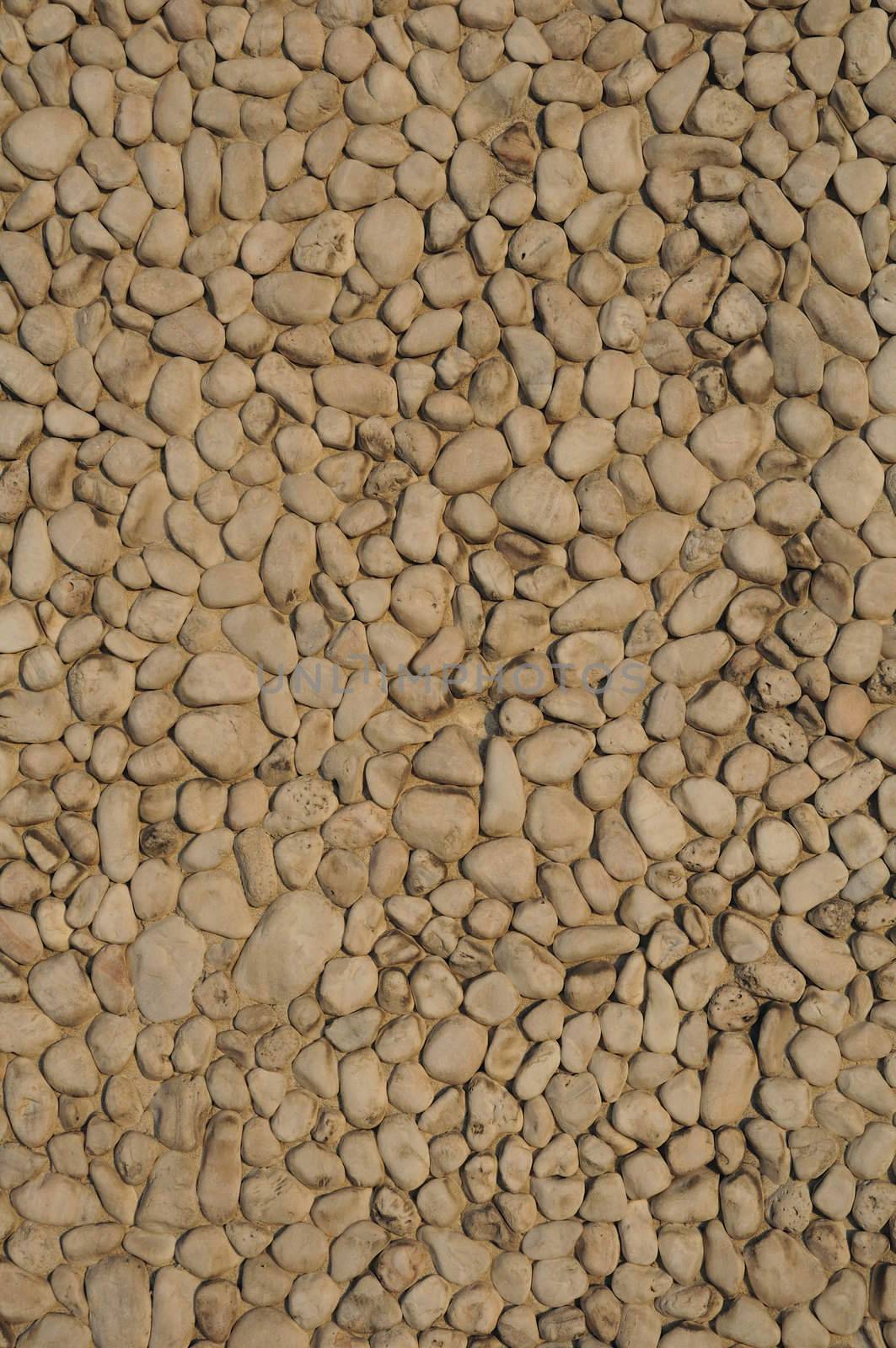 A wall of rounded pebbles packed closely together