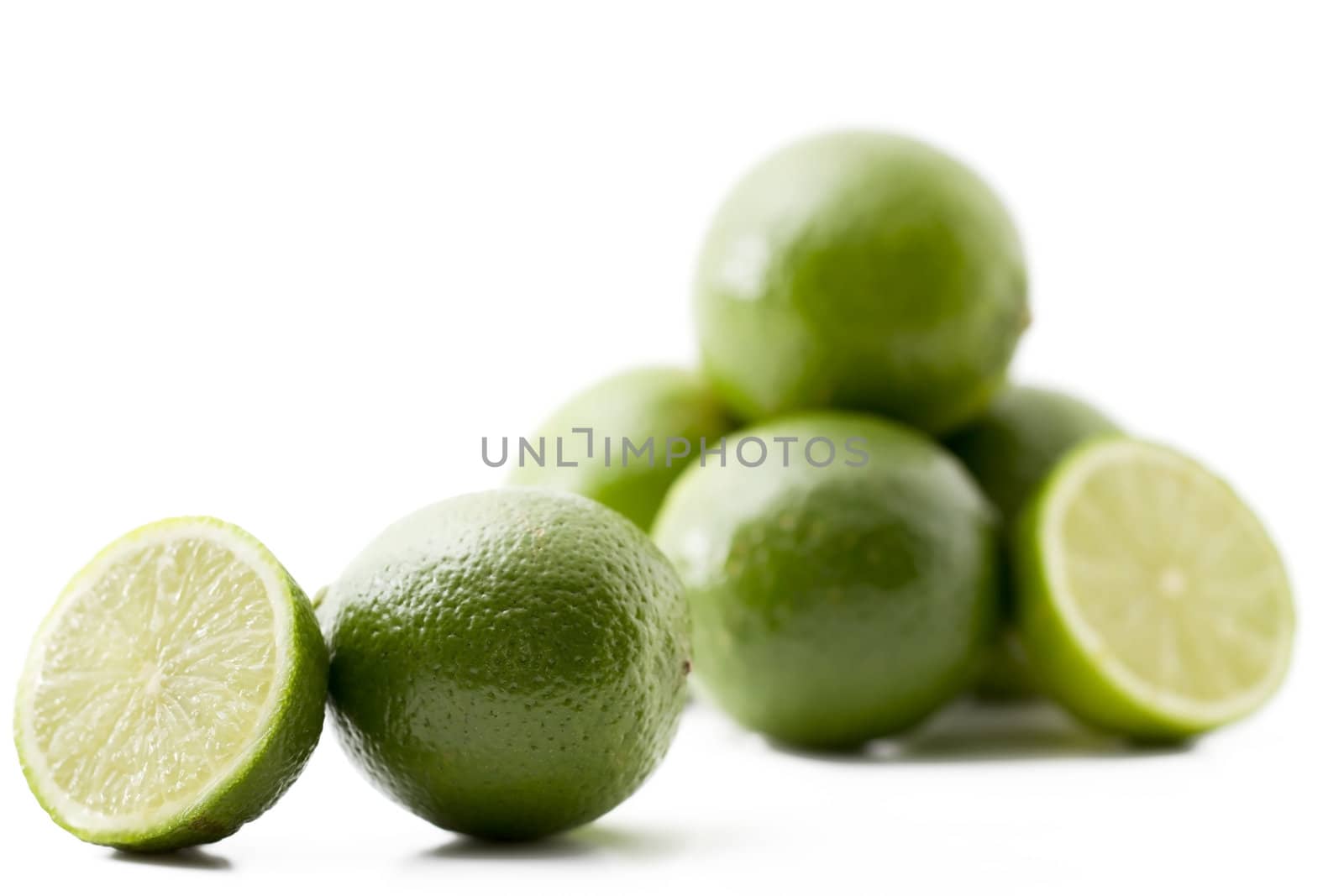 one lime and a half in front of others on white background